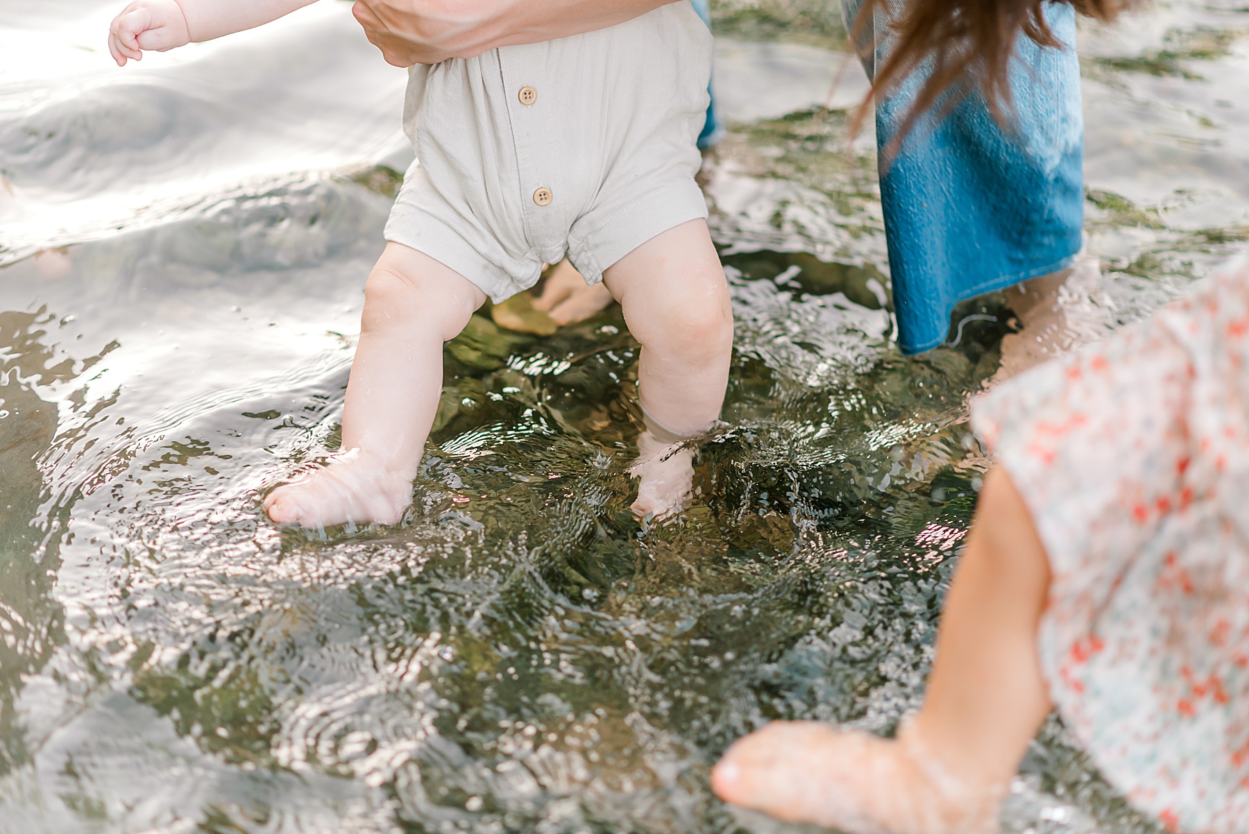 little boy dips toes in water