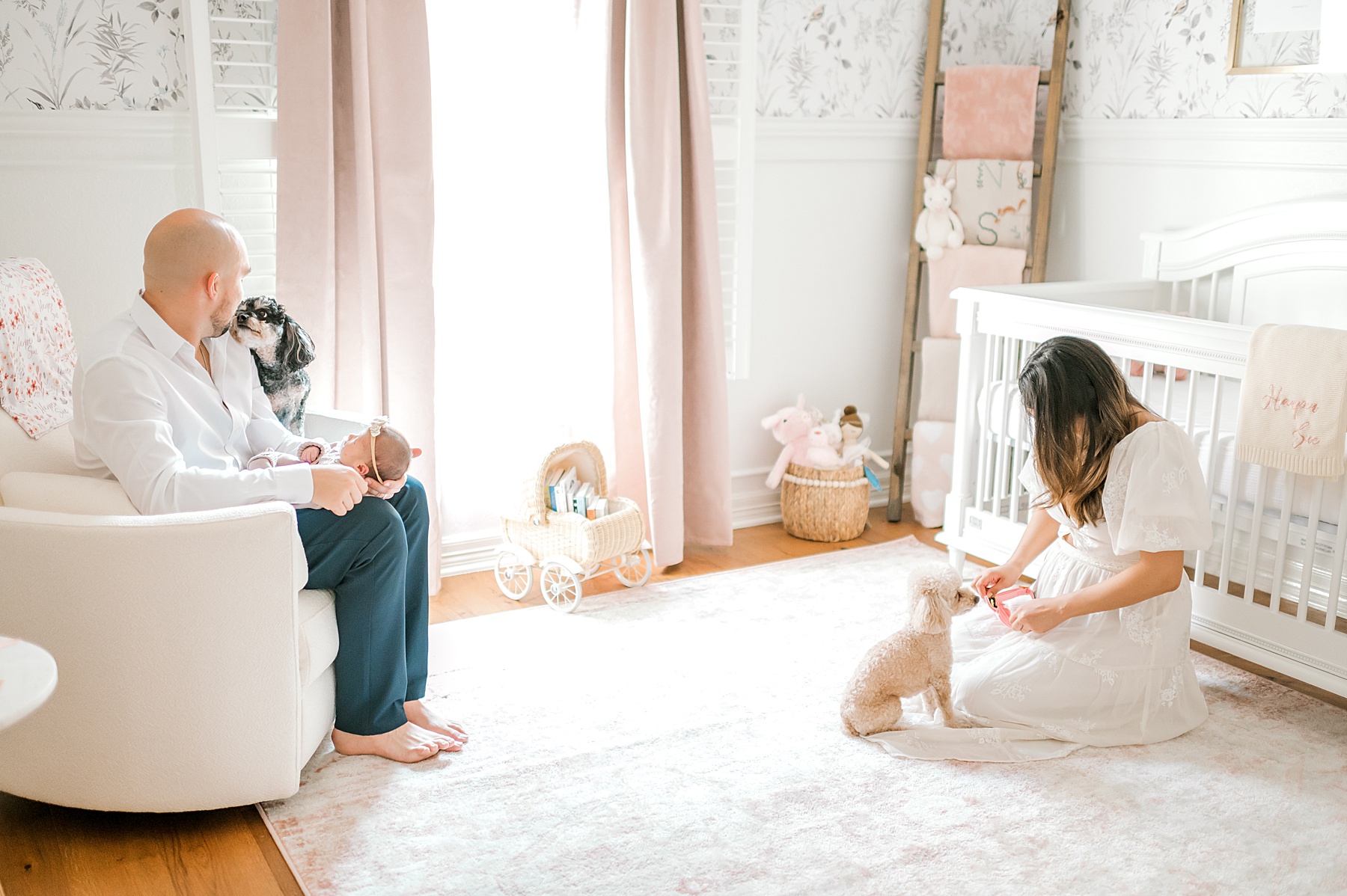 parents sit with newborn in nursery | Rescheduling in-home sessions Due to Weather | Why Natural Light Matters for In-Home Newborn Sessions
