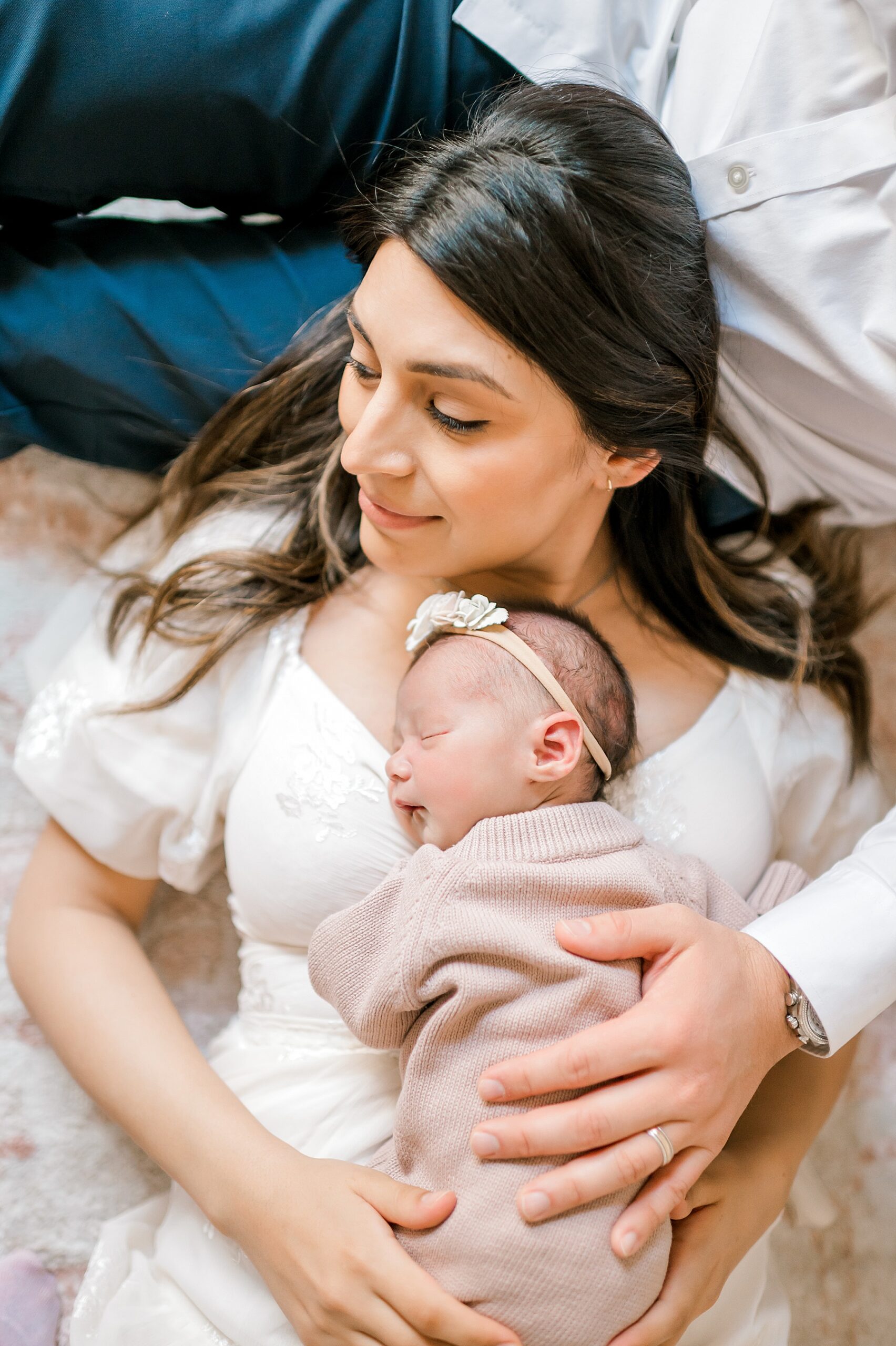 mom lays with newborn on chest during in home session