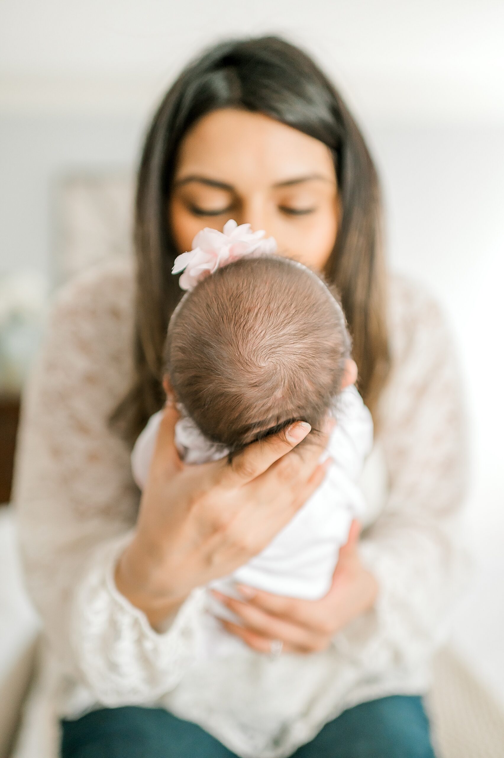 mom kisses newborn girl