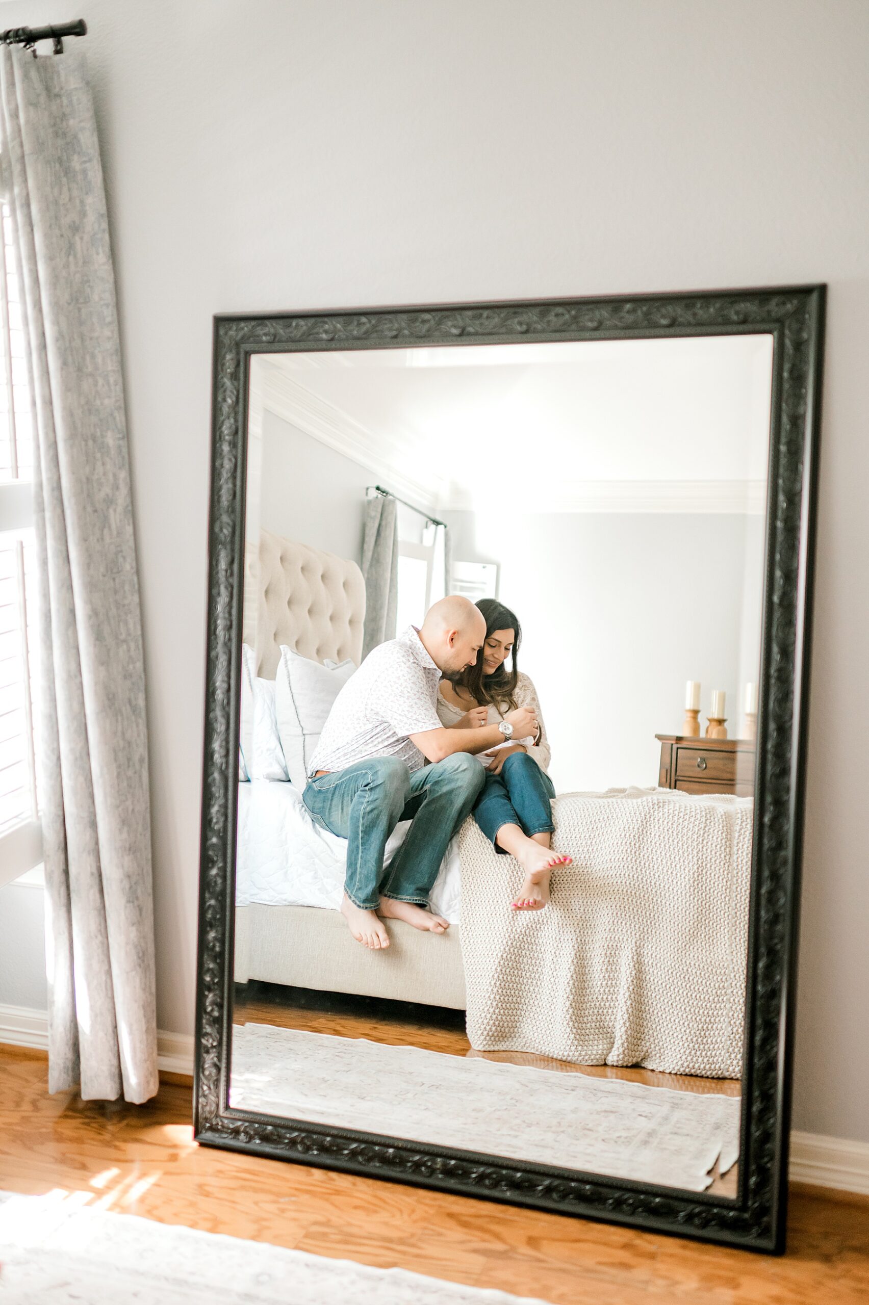 reflection of family in mirror | Rescheduling n-Home Newborn Sessions Due to Weather | Why Natural Light Matters