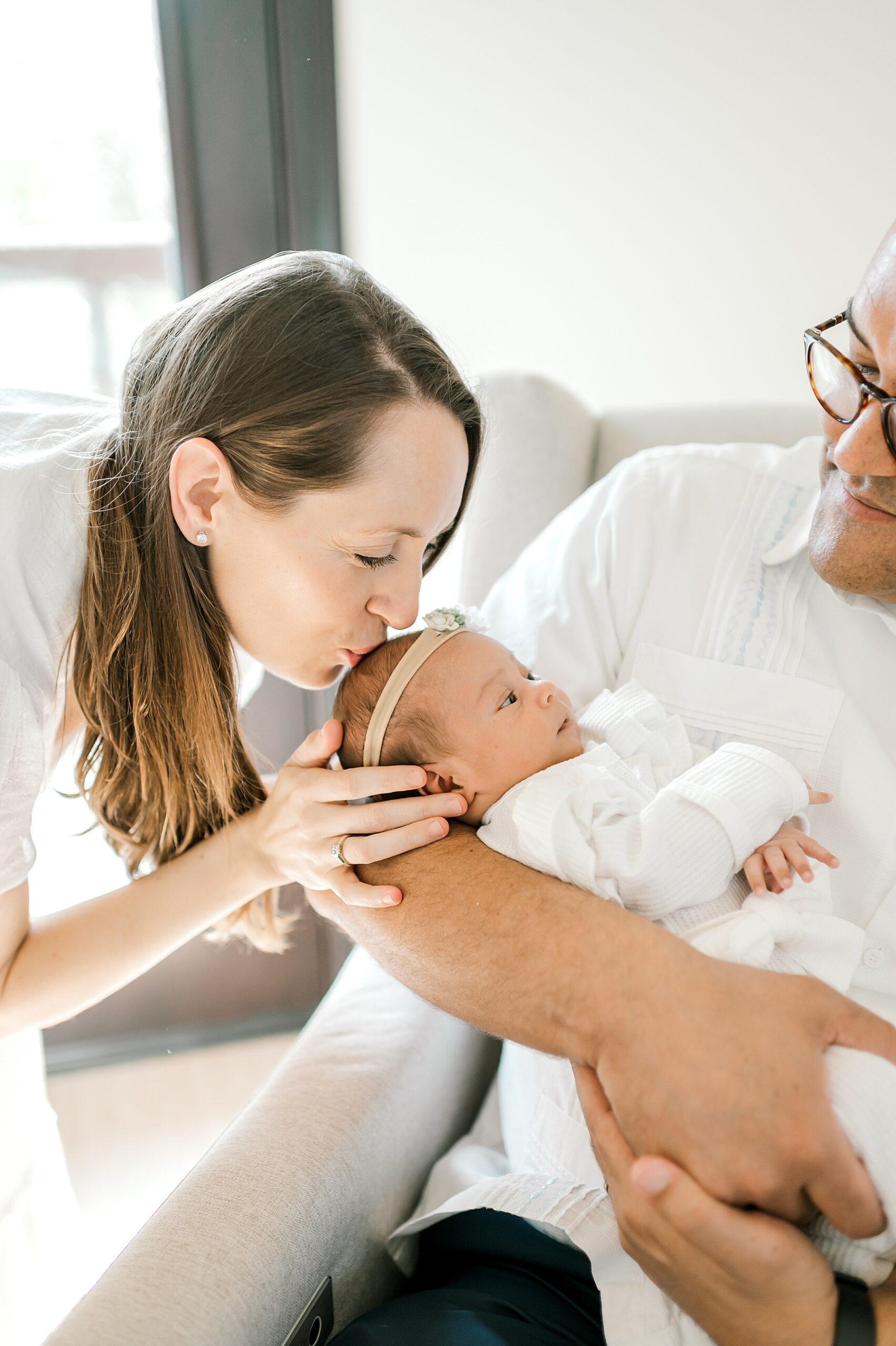 mom kisses newborn's head