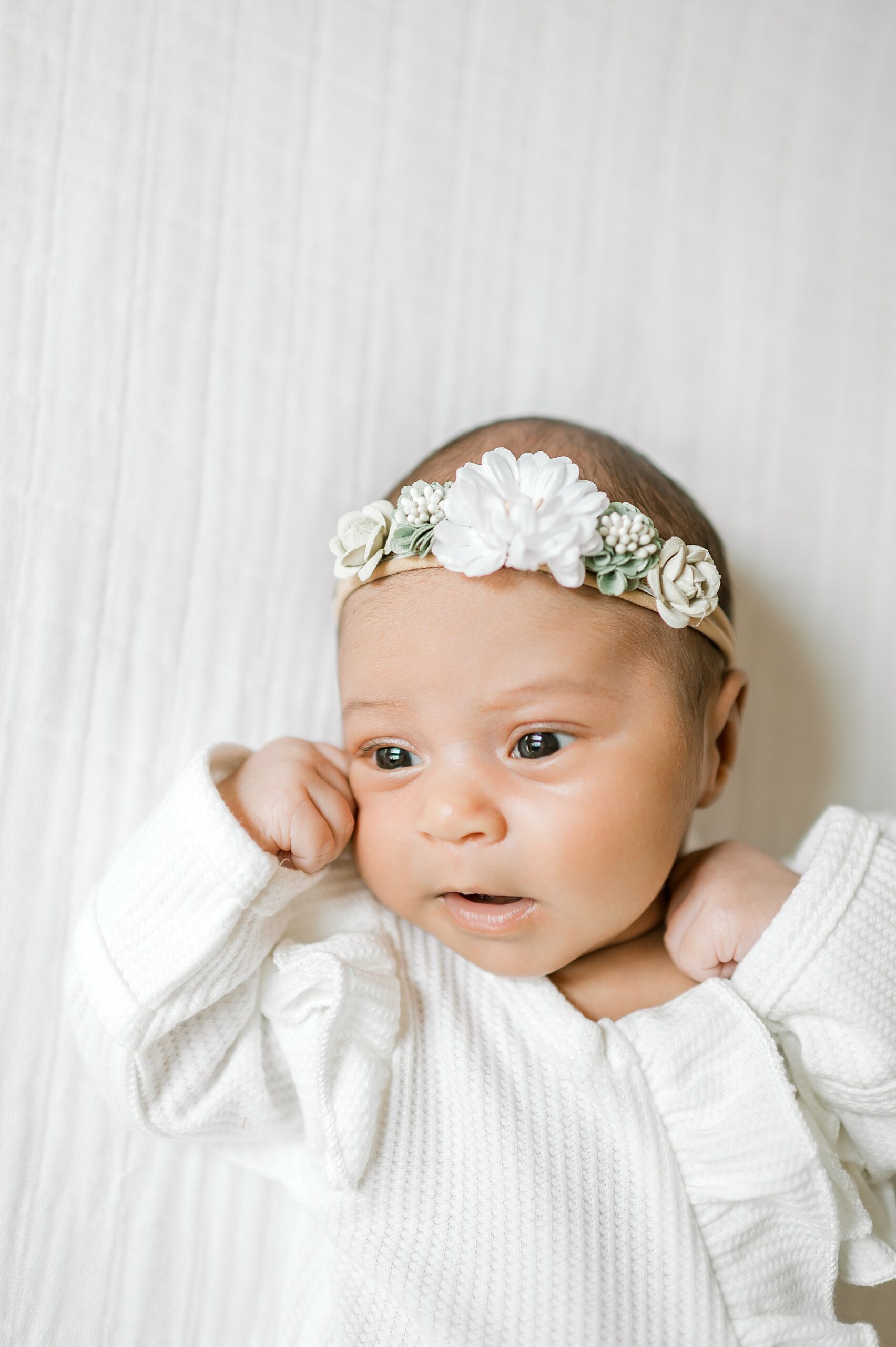 Simple and Sweet Newborn Session of newborn girl in white outfit