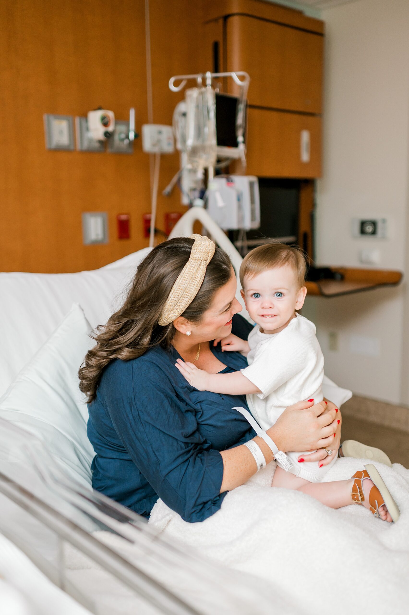 little boy sits with his mom in hospital