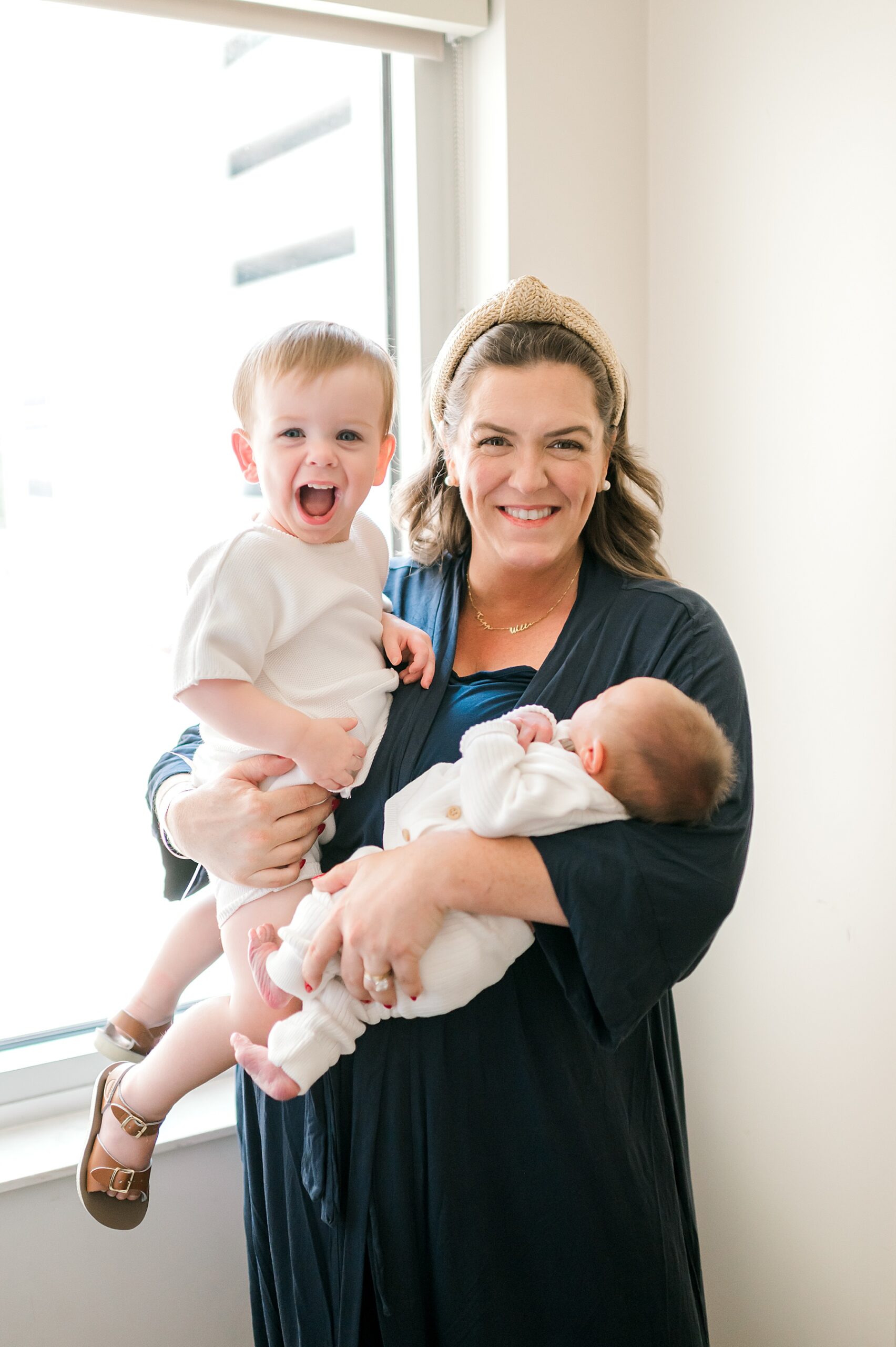 mom holds both her sons in arms