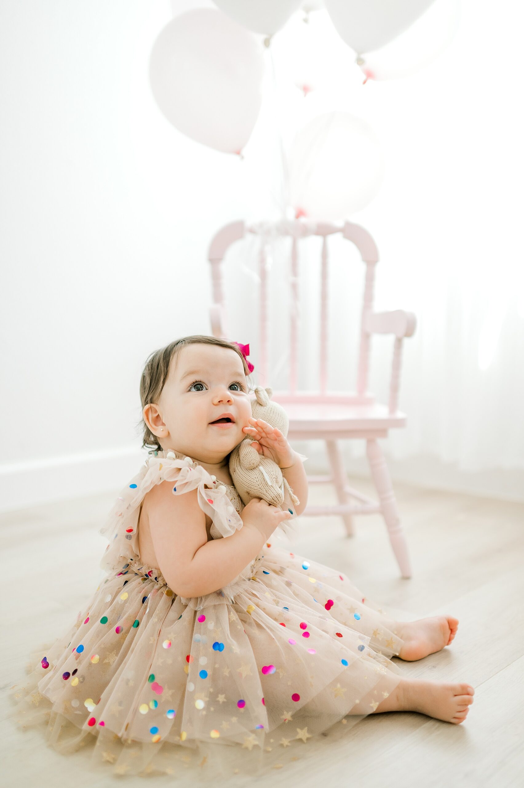 little girl hugs stuffed animal during Studio Milestone Session in Bulverde, TX