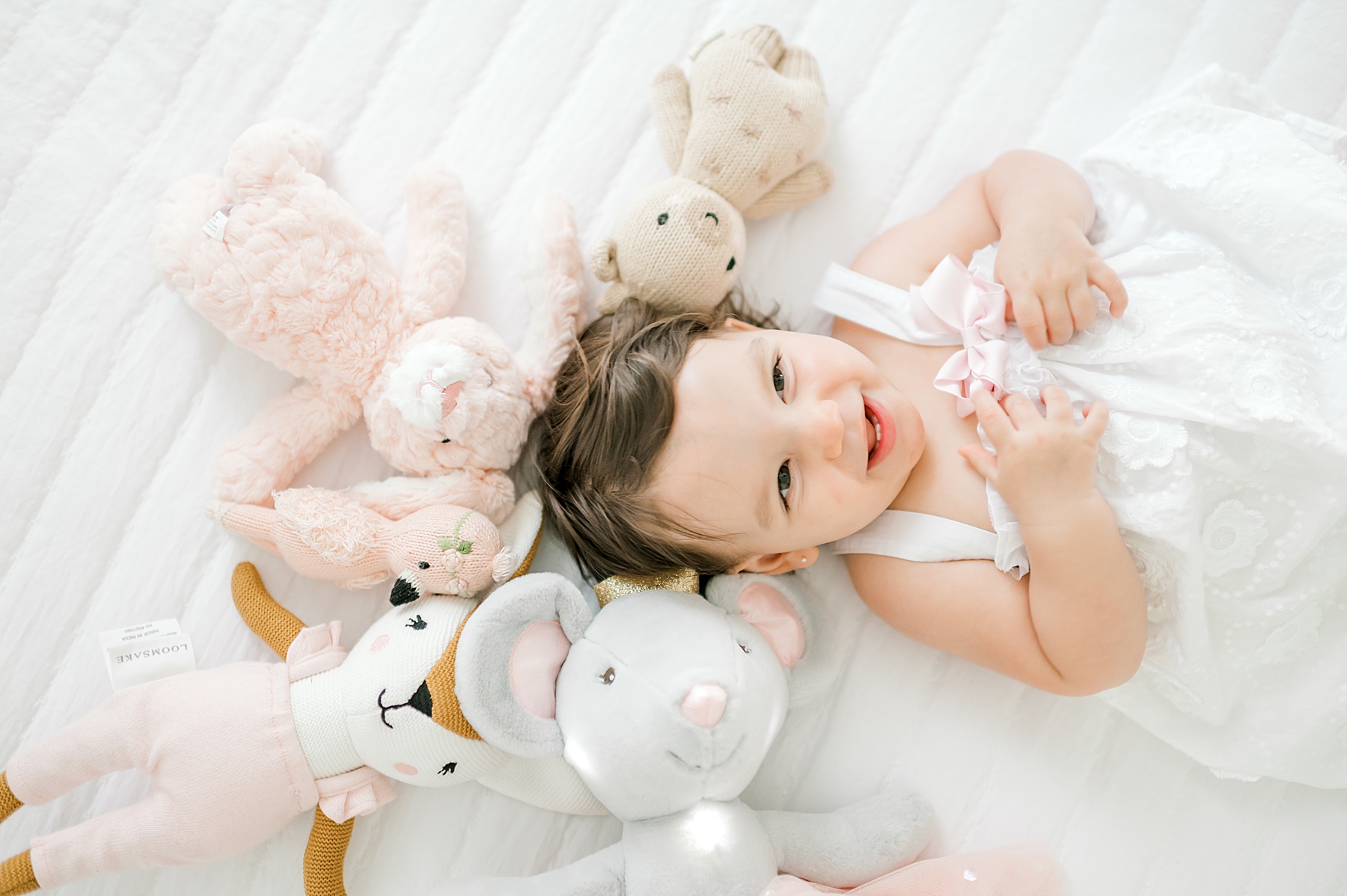 stuffed animals surround little girl during Studio Milestone Session in Bulverde, TX