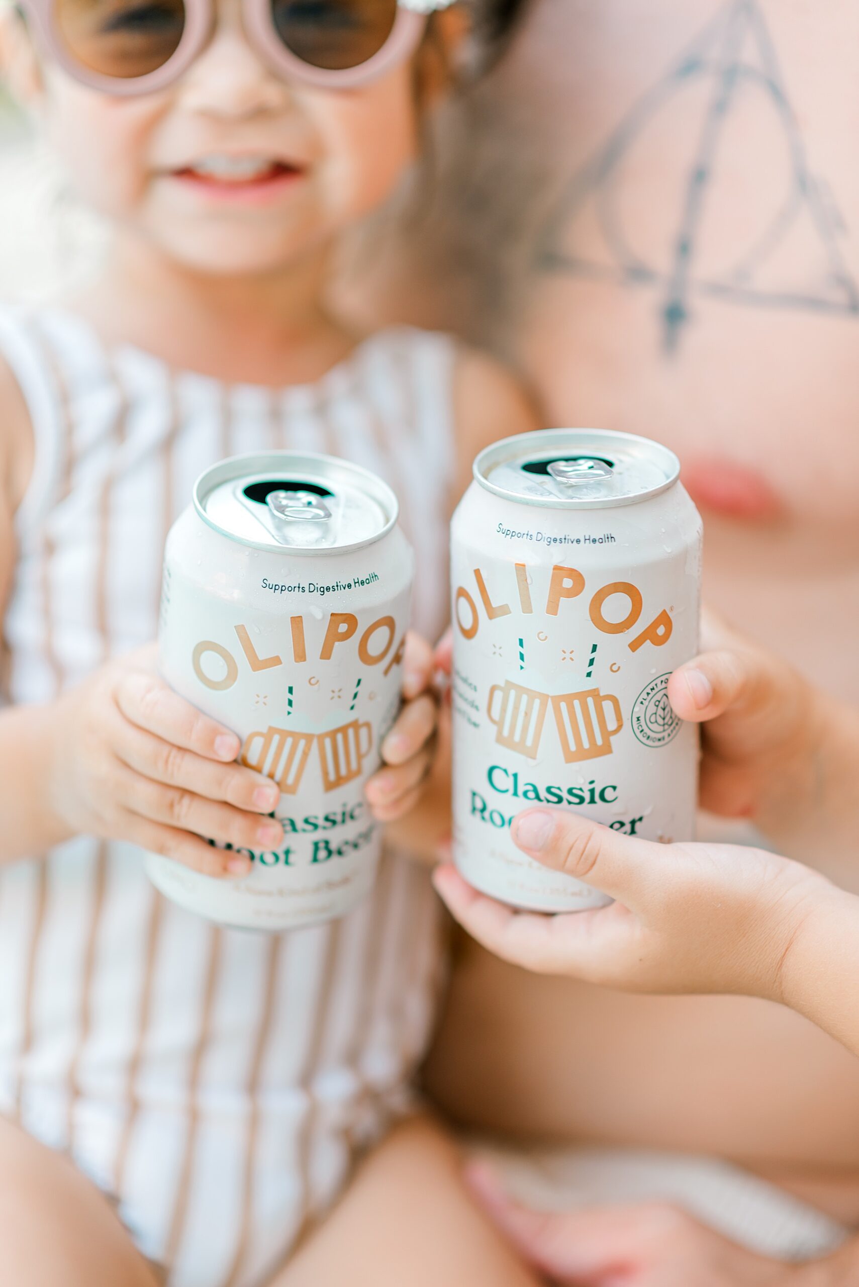 kids drink cans of olipop during at home pool family session