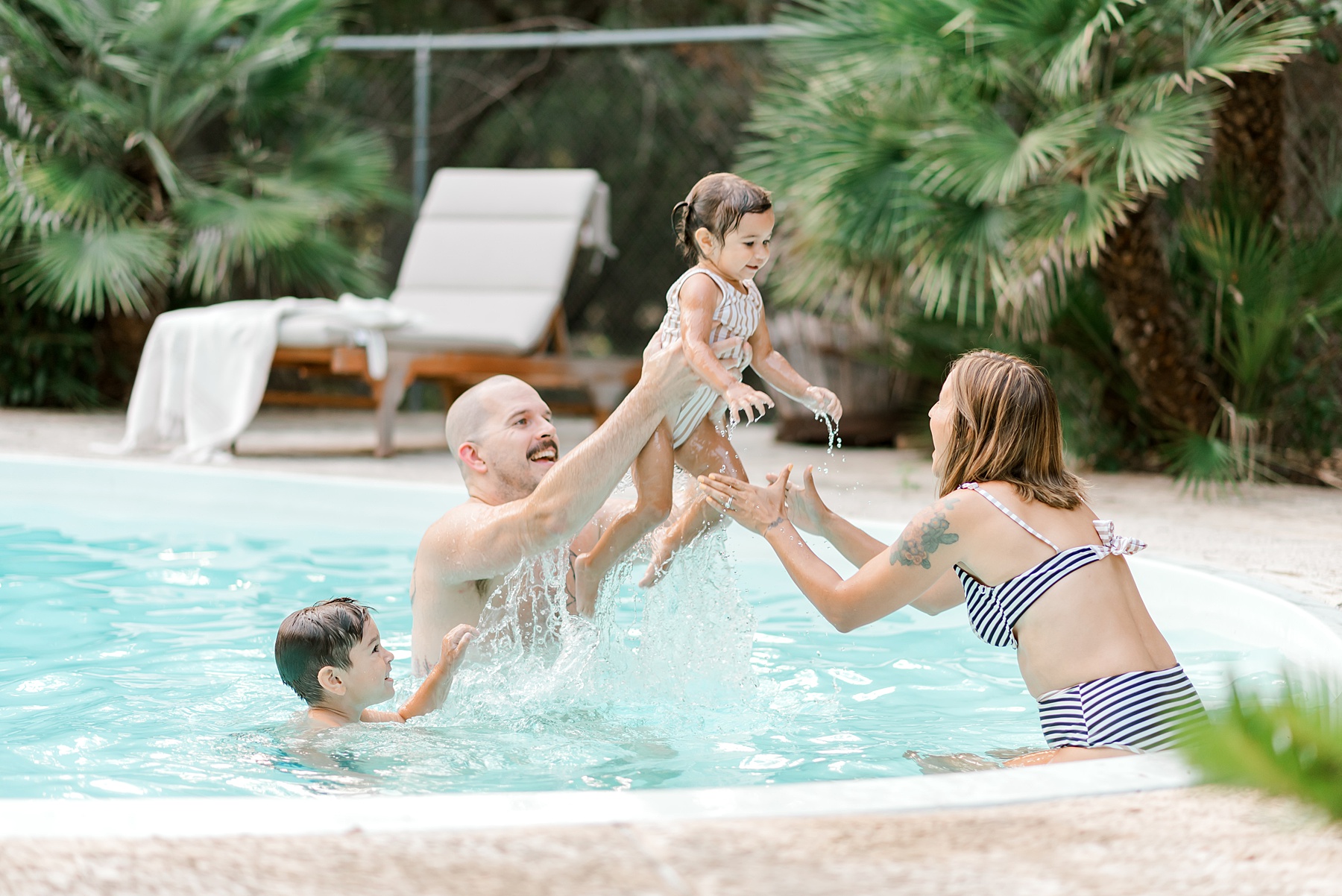 dad plays with kids in pool during Backyard Pool Party Summer Family Session
