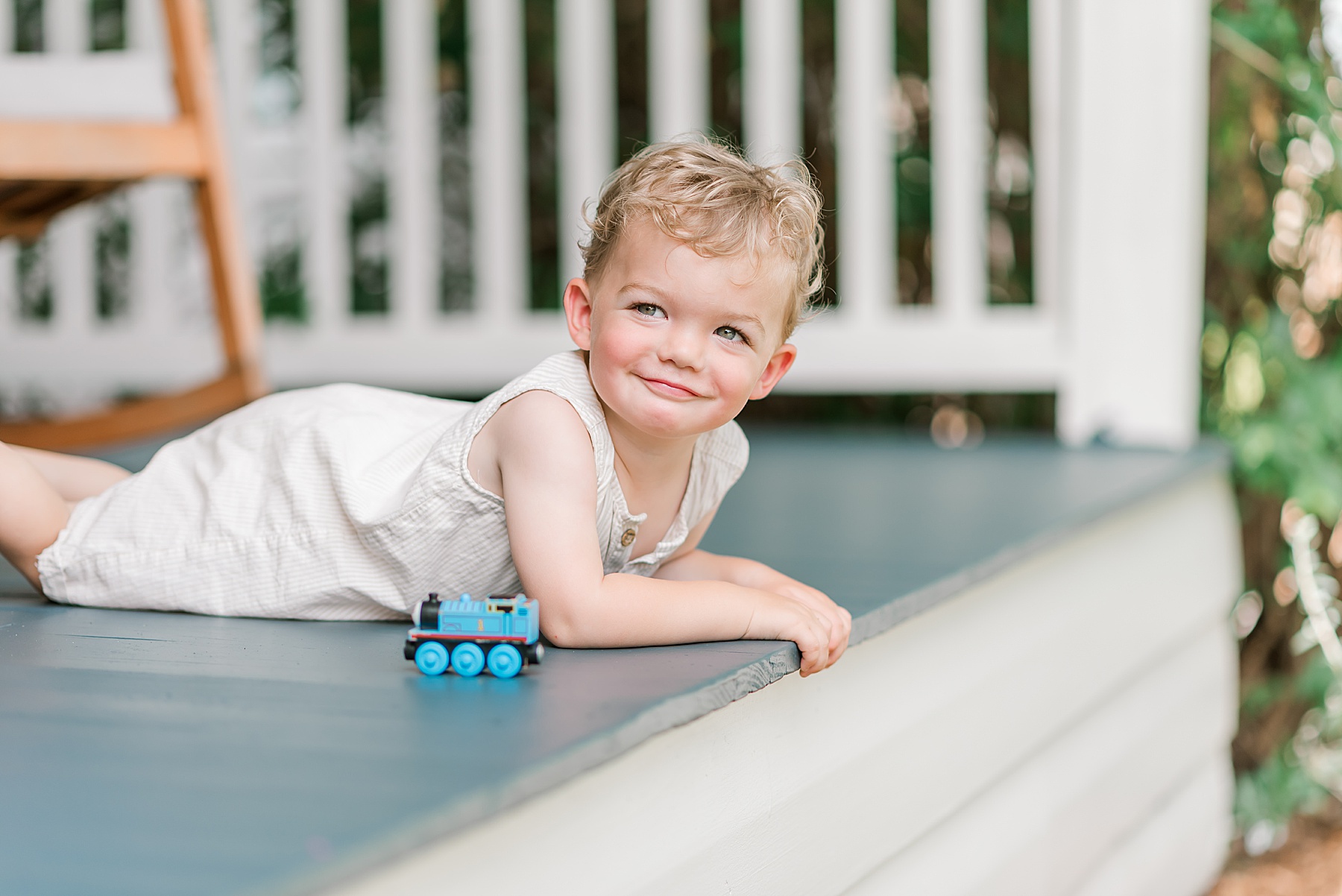 little boy plays with Thomas the Train