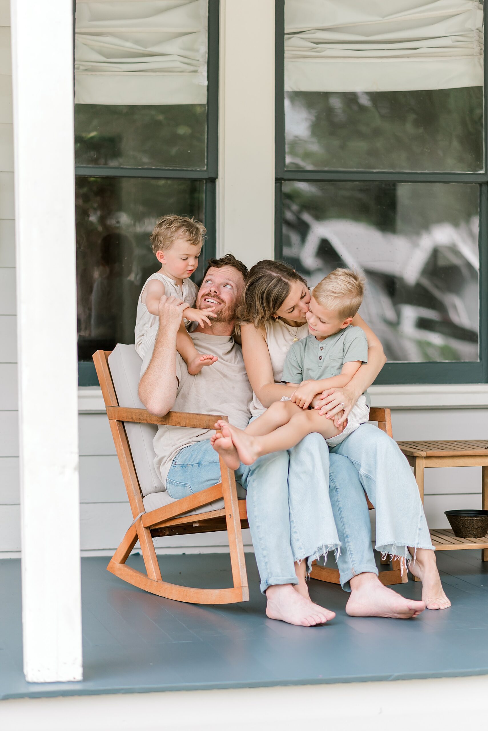 family sits together on rocking chair