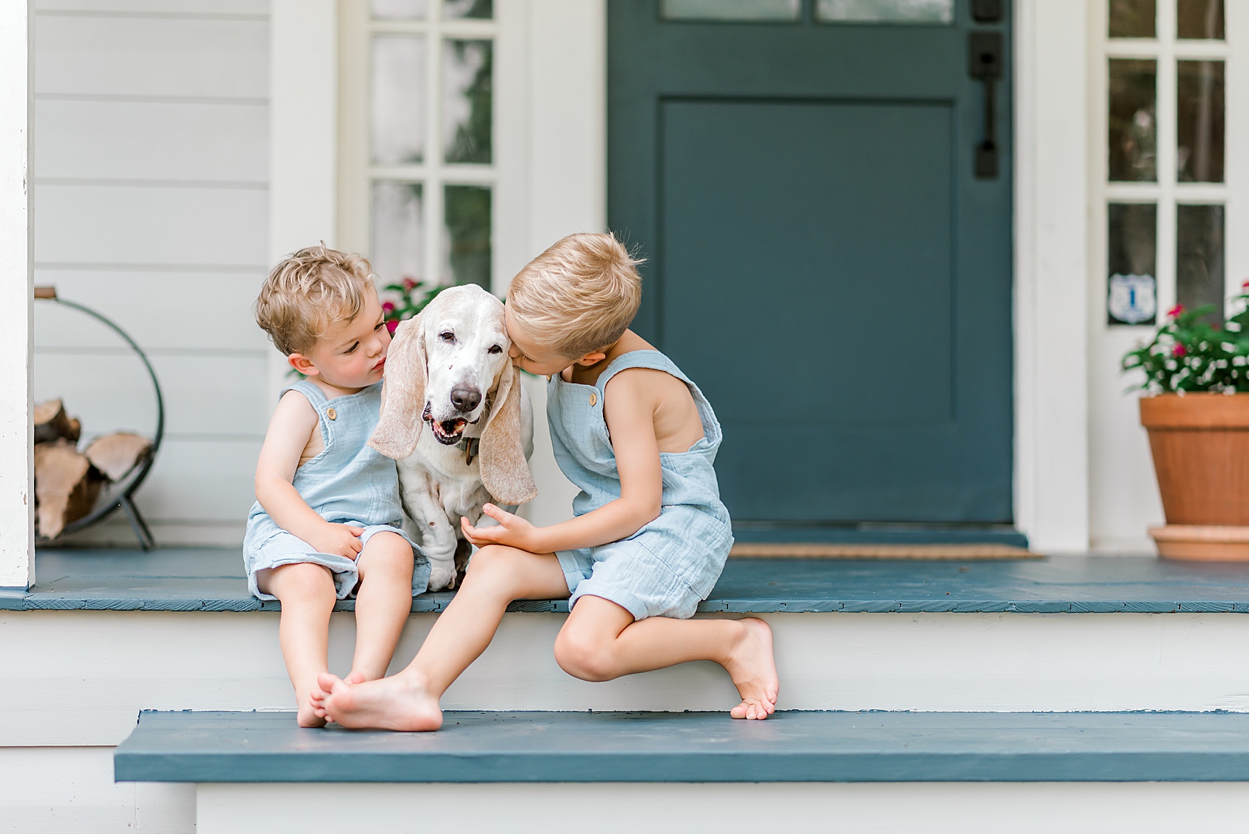 kids kiss their family dog