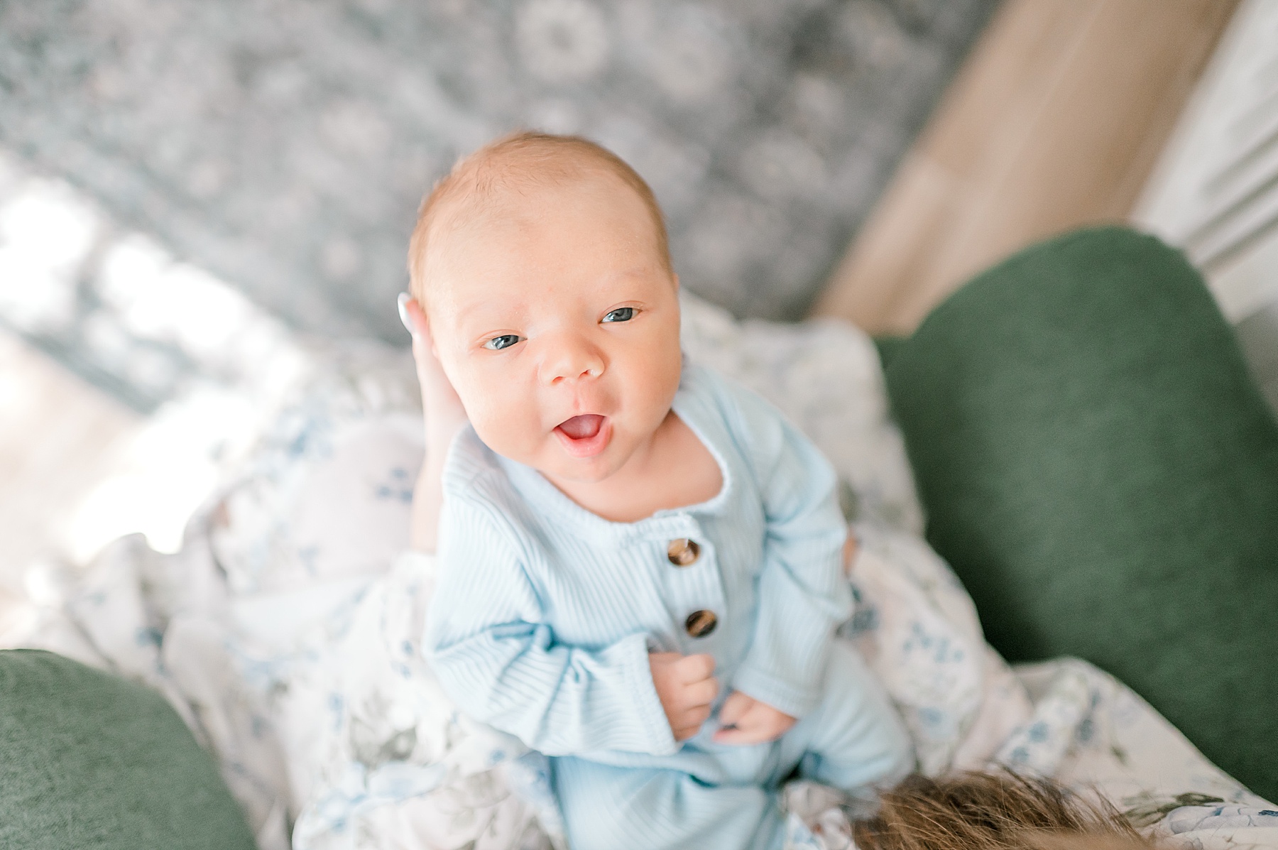 newborn in baby blue onesie 
