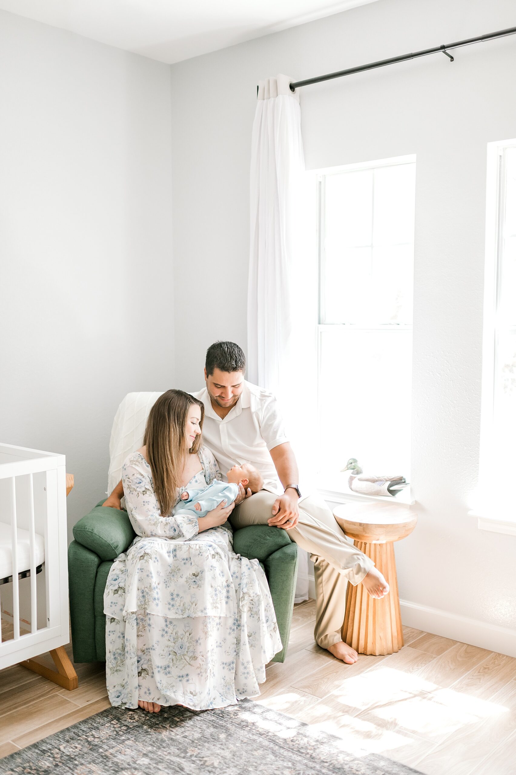 new parents hold baby boy in nursery | Styling Tips for Newborn Sessions  
