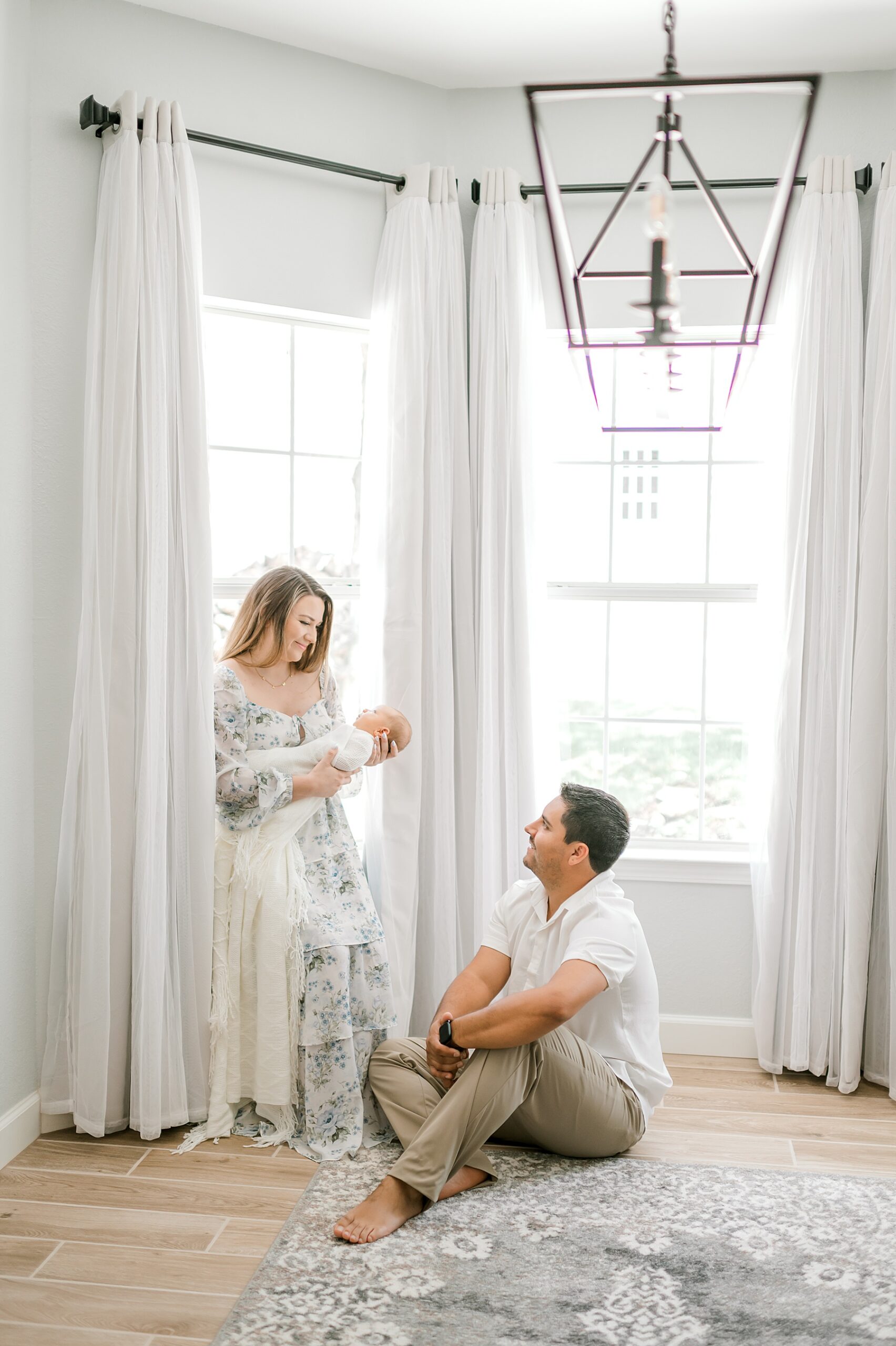 Styling Tips for Newborn Sessions | parents cradle newborn in Canyon Lake, TX Home