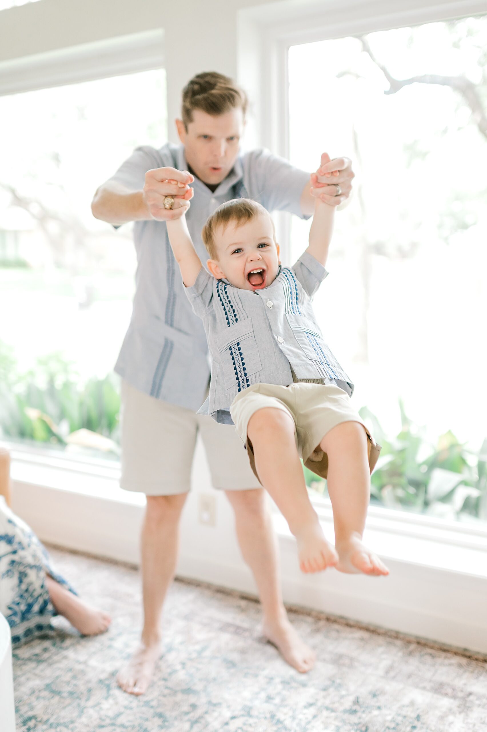 dad swings son in arms