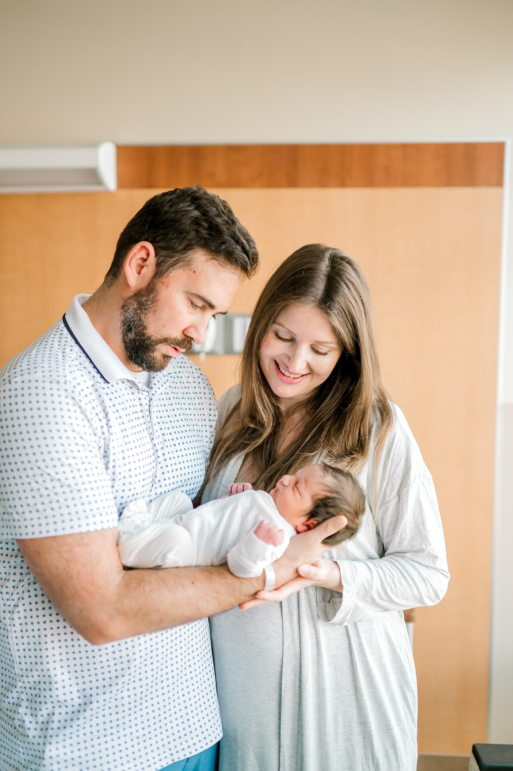 parents admire newborn 