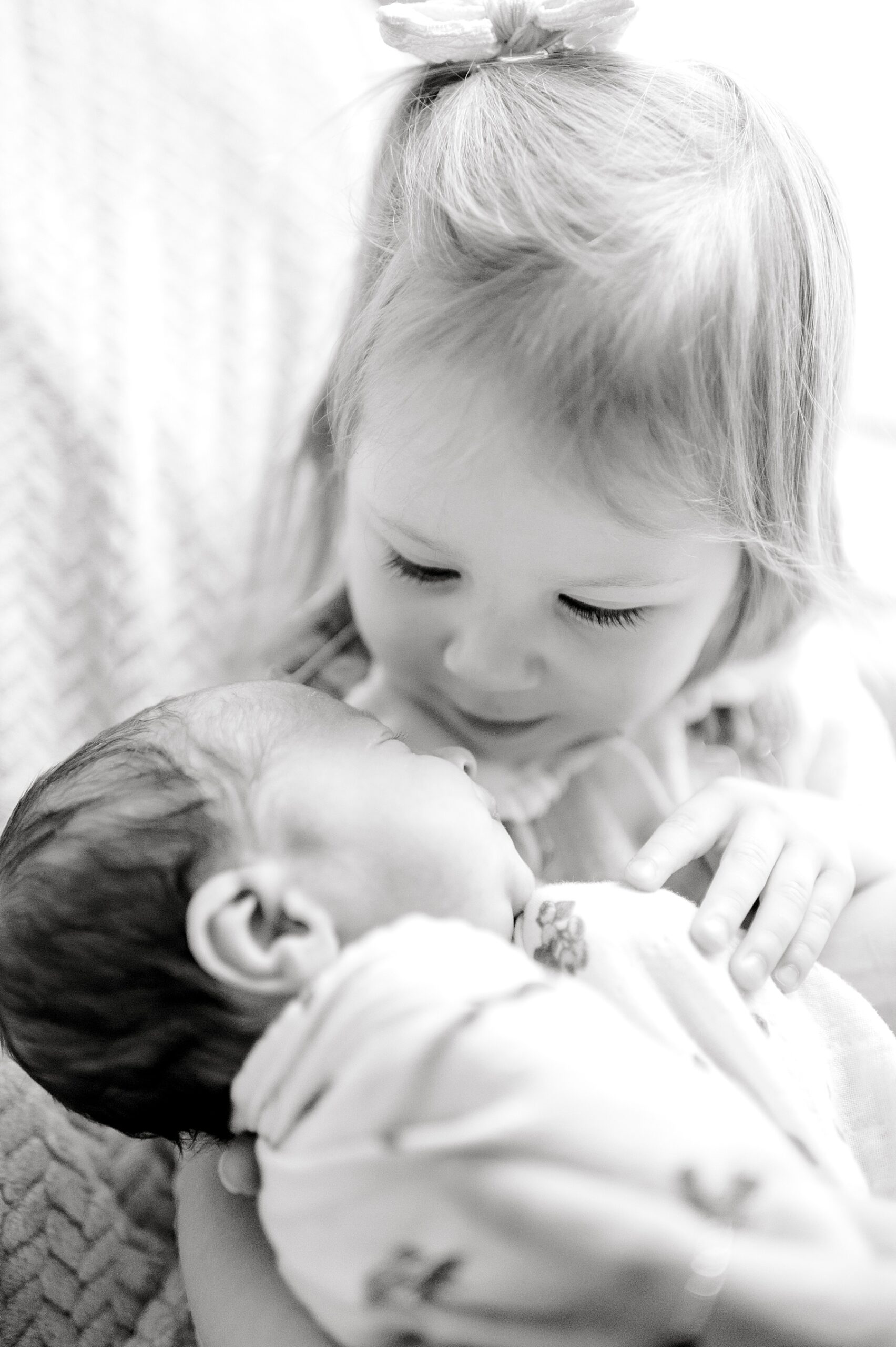 big sister holds newborn brother | Why I Love Including Toddlers in Newborn Sessions 