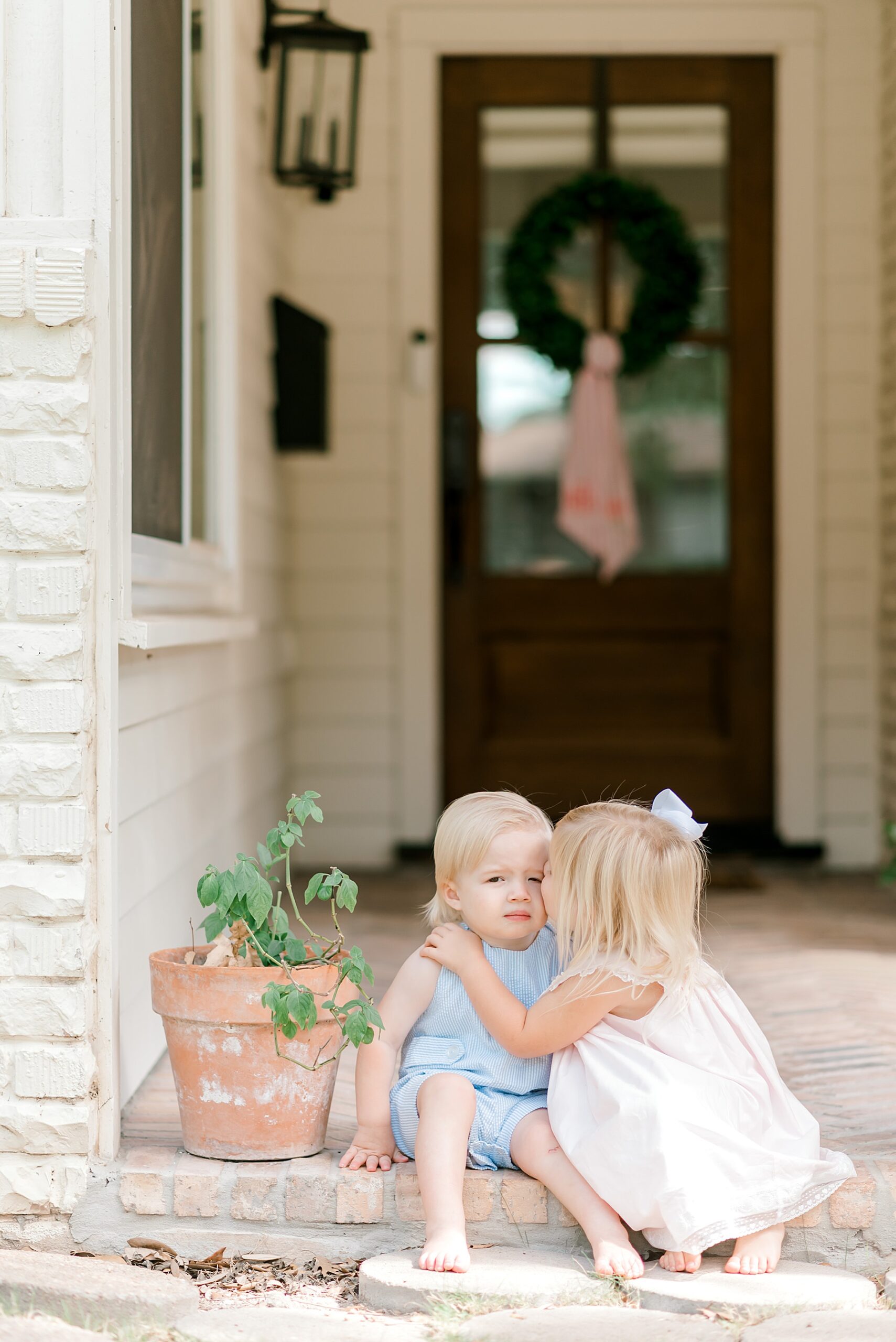 siblings in front of house during in-home session