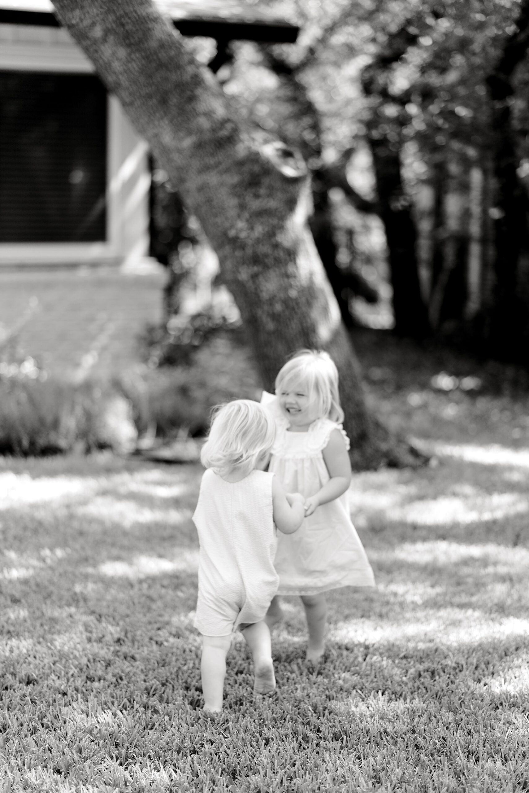 siblings play joyfully in yard of home | What You Don't Need For an In-Home Session by Bulverde, TX Photographer