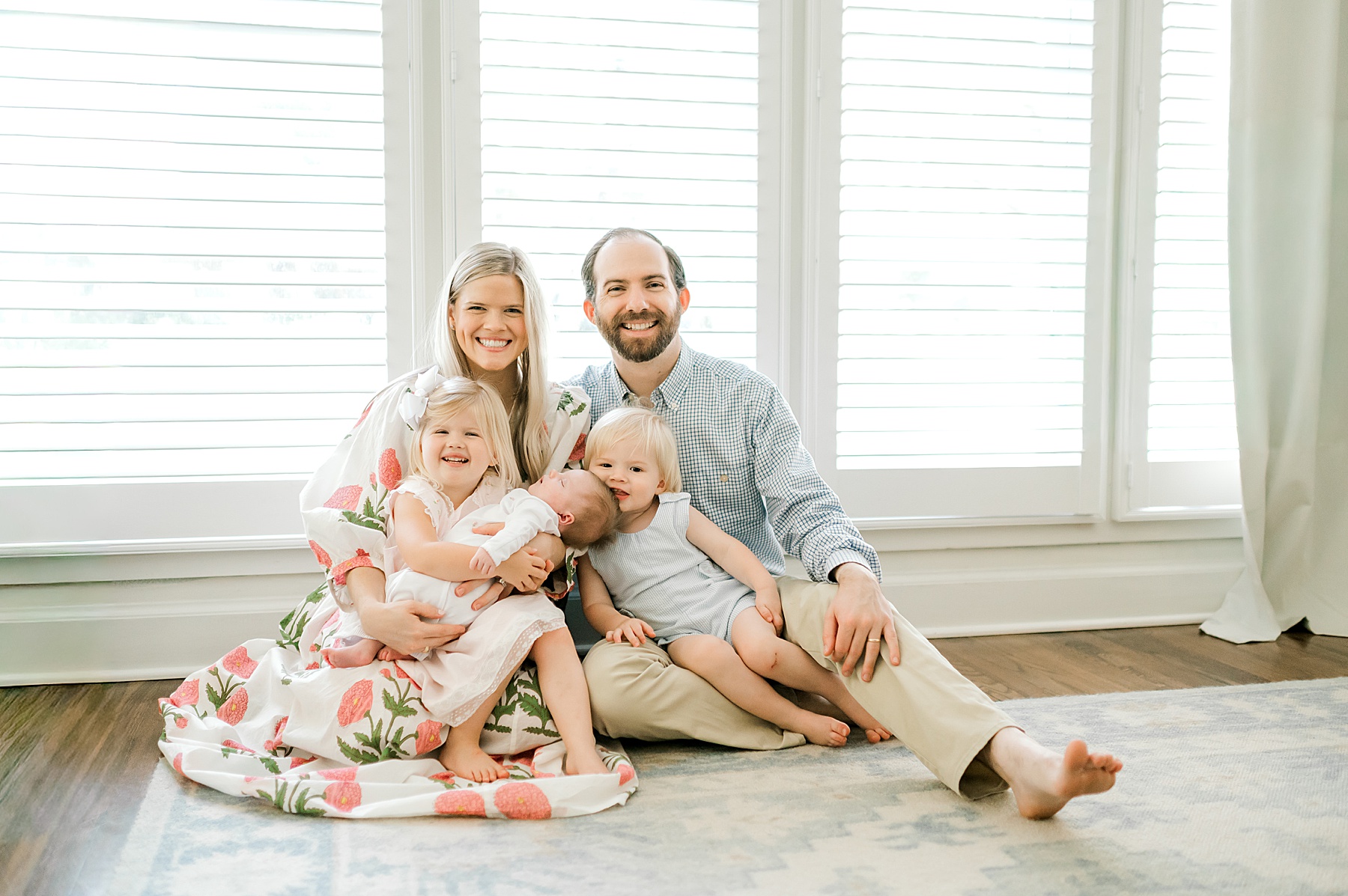 in-home newborn and family portraits by window 