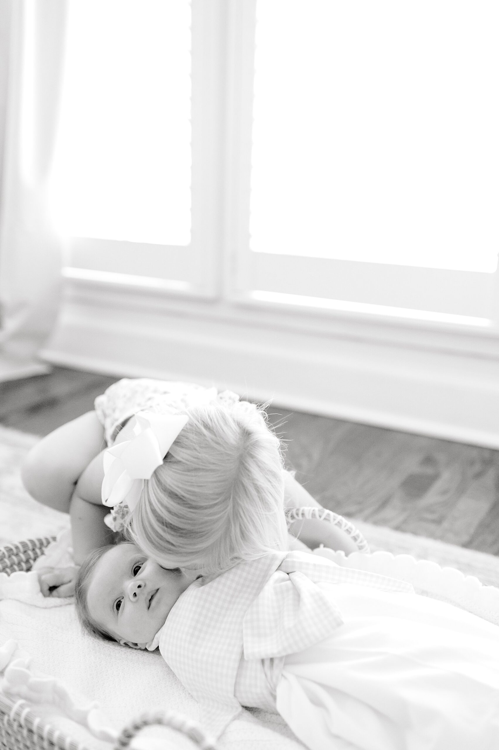 big sister kisses newborn sister