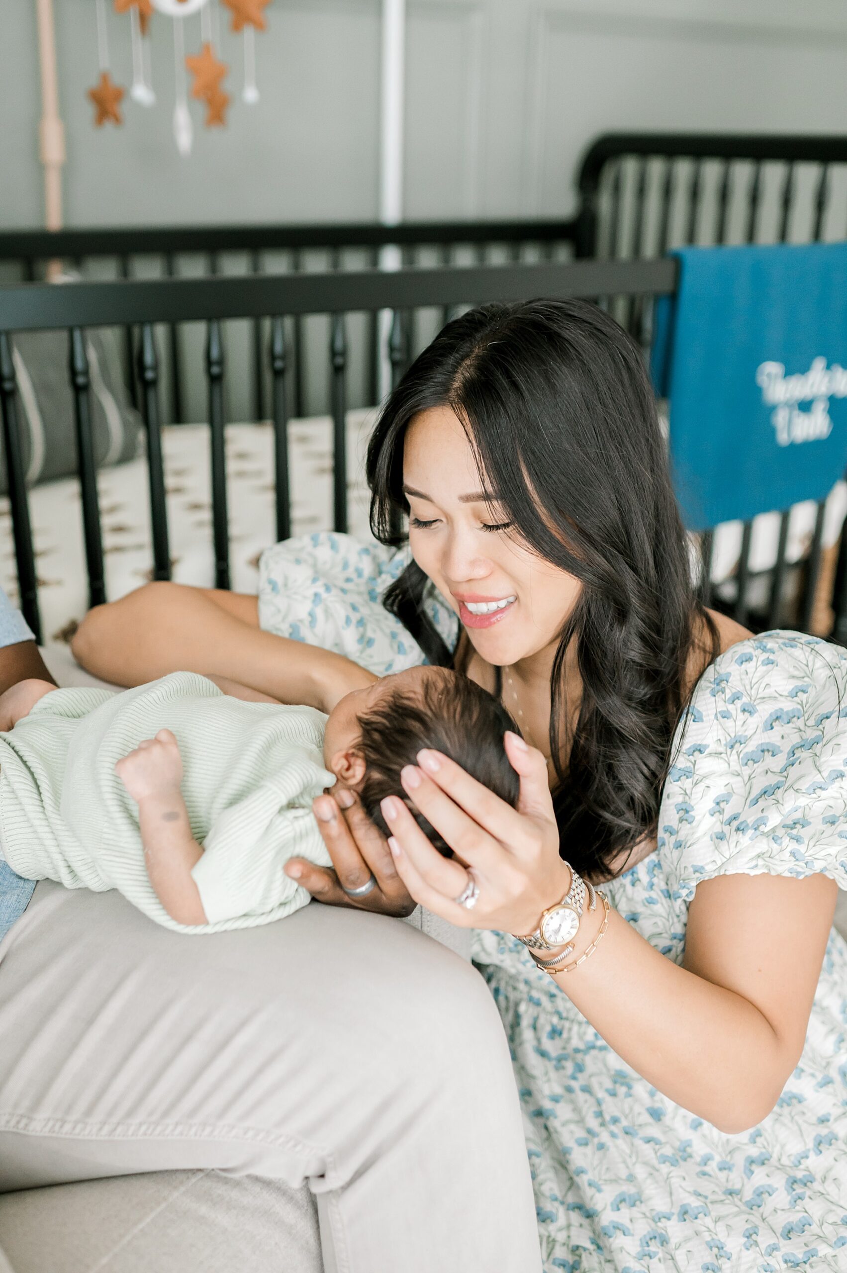 mom looks down at newborn 