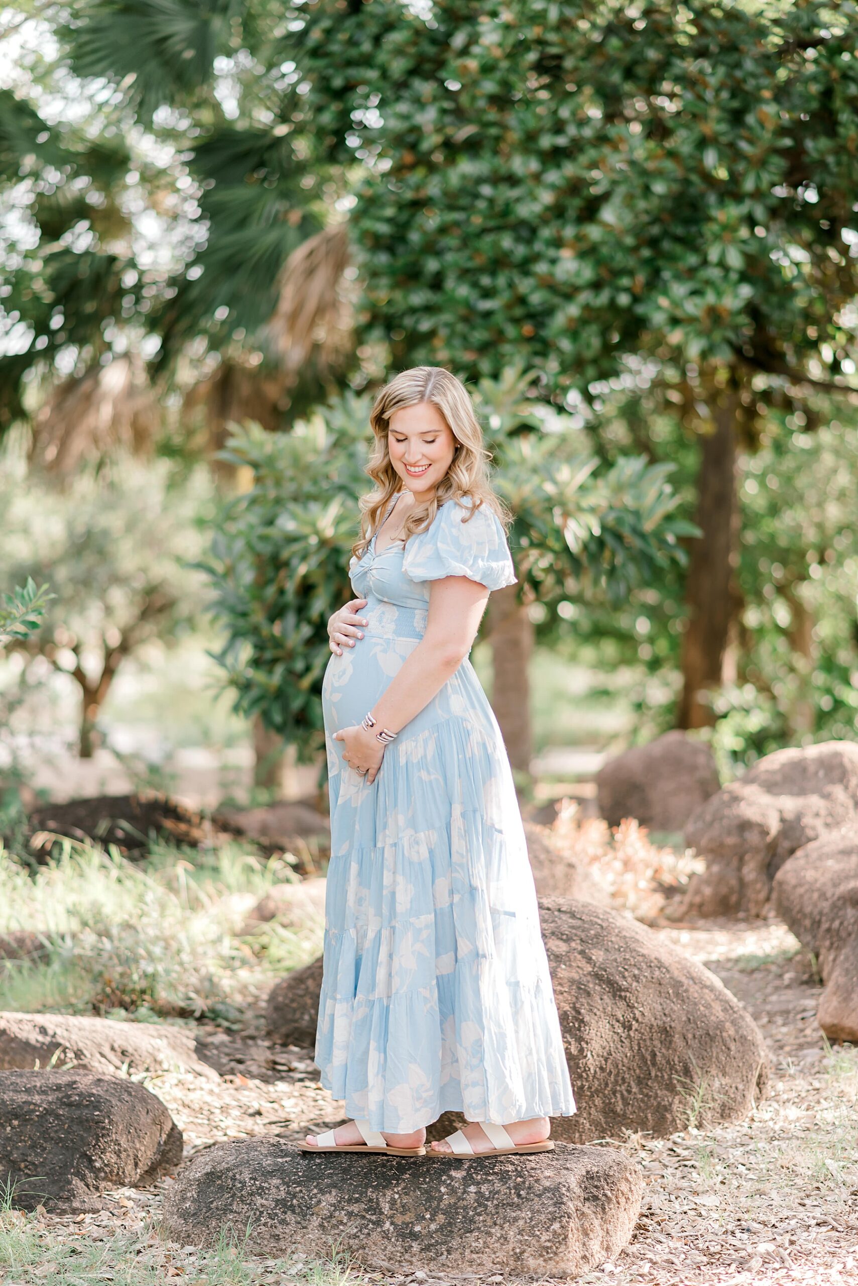 expectant mom in light blue and white flowy dress