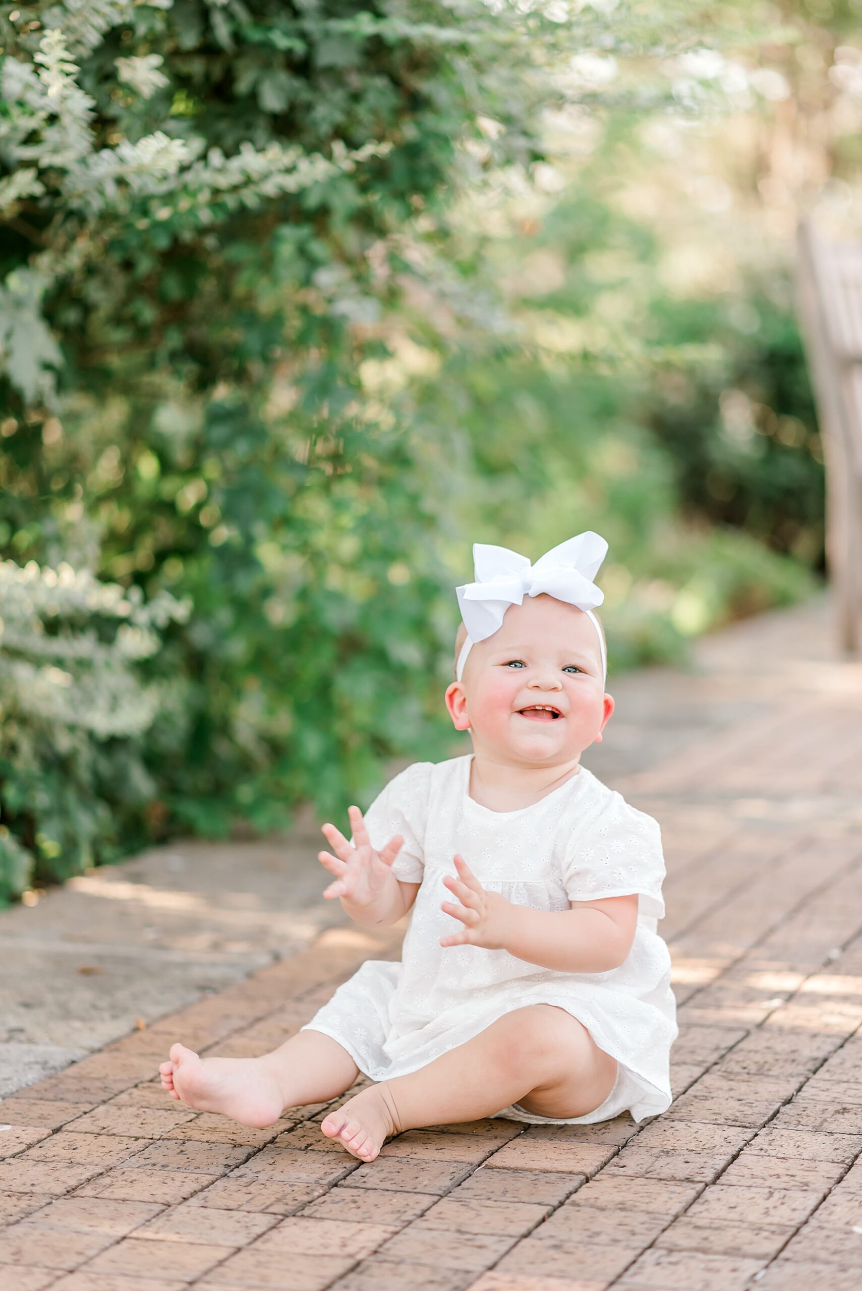 baby girl claps and smiles 