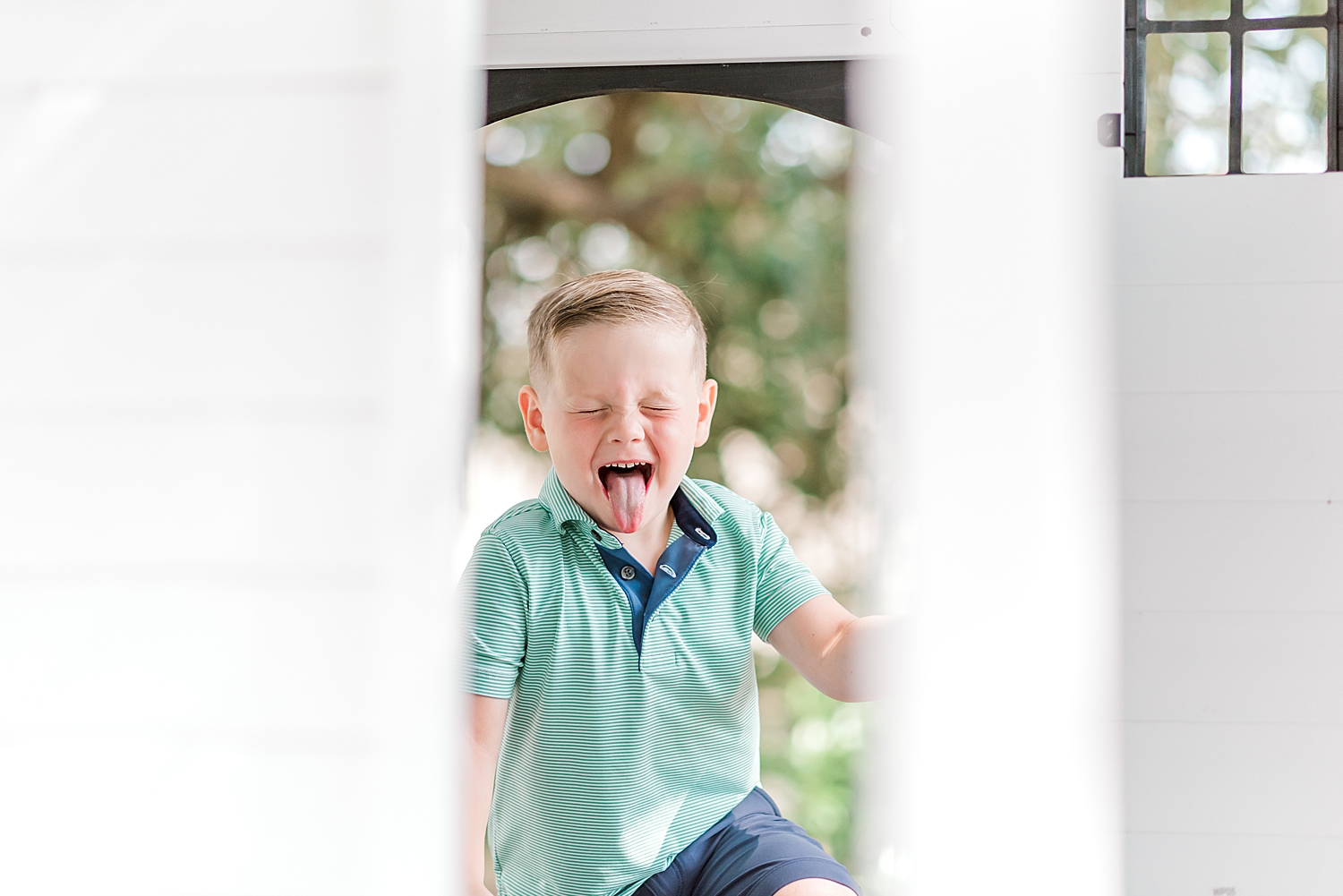 candid photo of little boy making silly faces