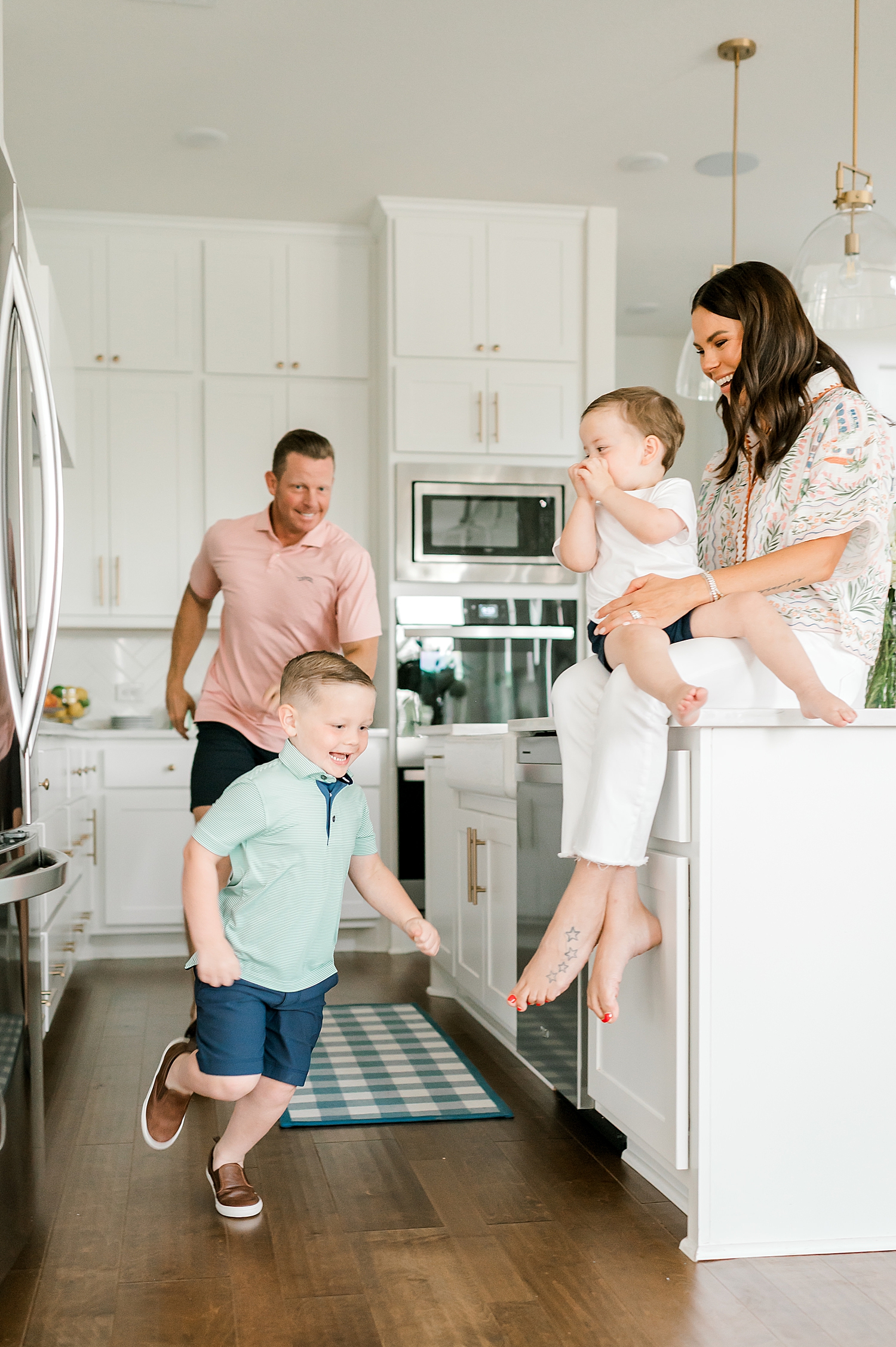 candid photo of dad chasing son through kitchen | What to Expect at Your In-Home Family Session