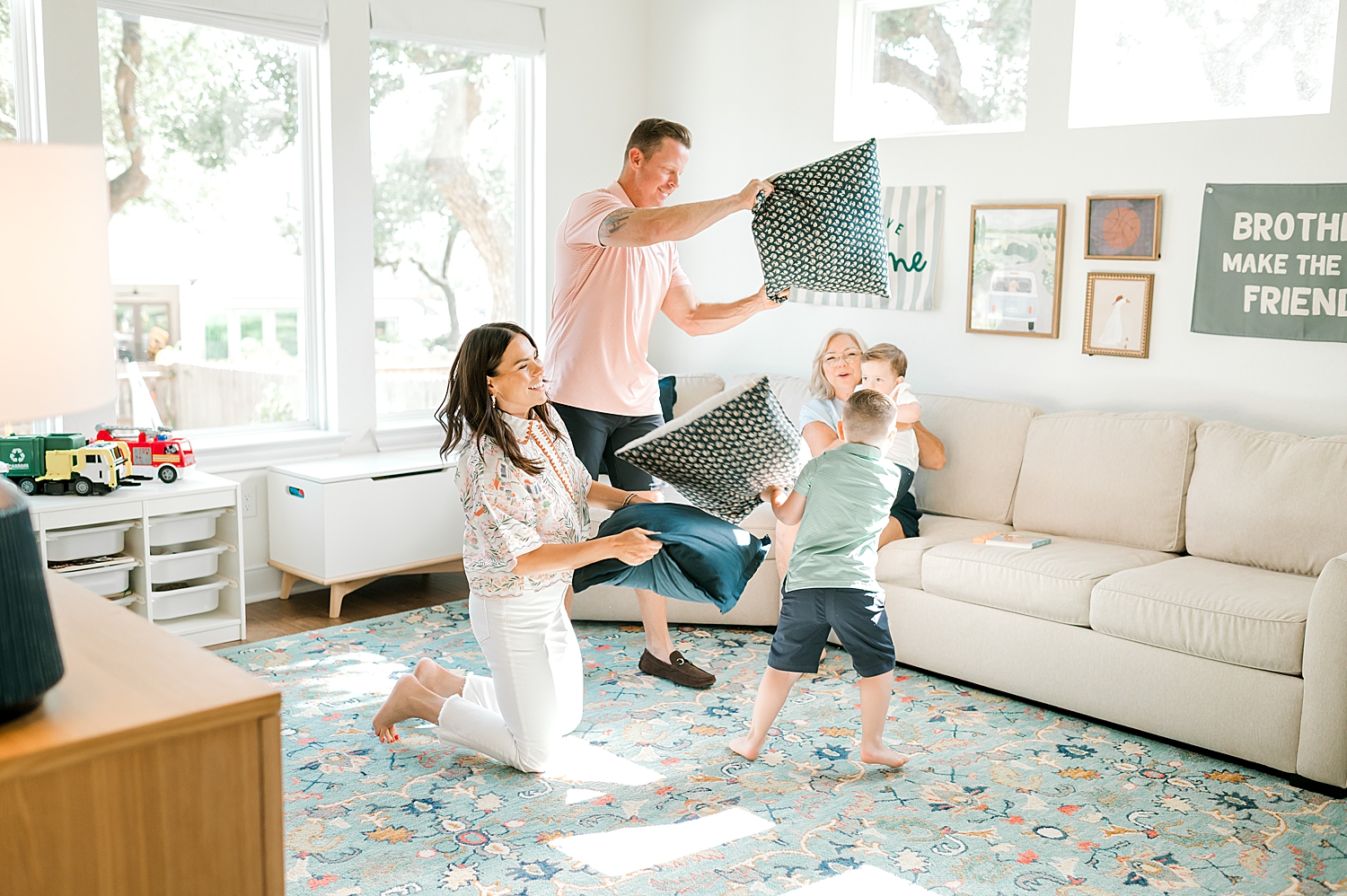candid family portraits during Boerne, TX family session | family pillow fight | What to Expect at Your In-Home Family Session