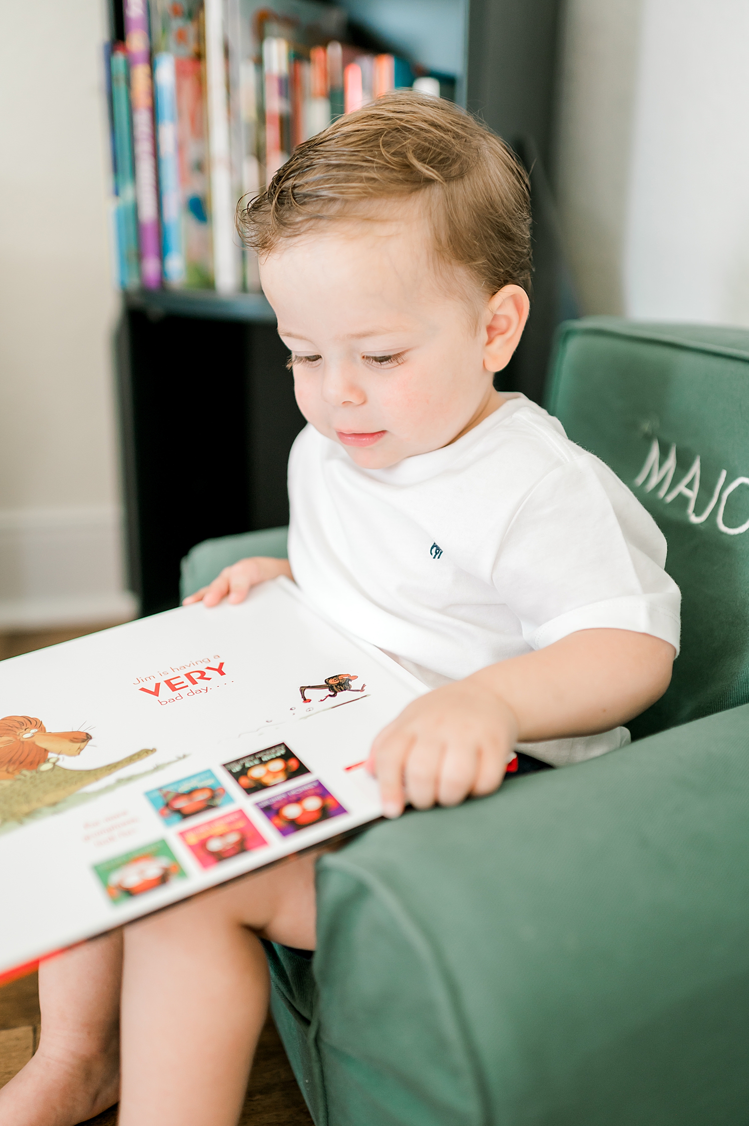 little boy reading during in-home family session.