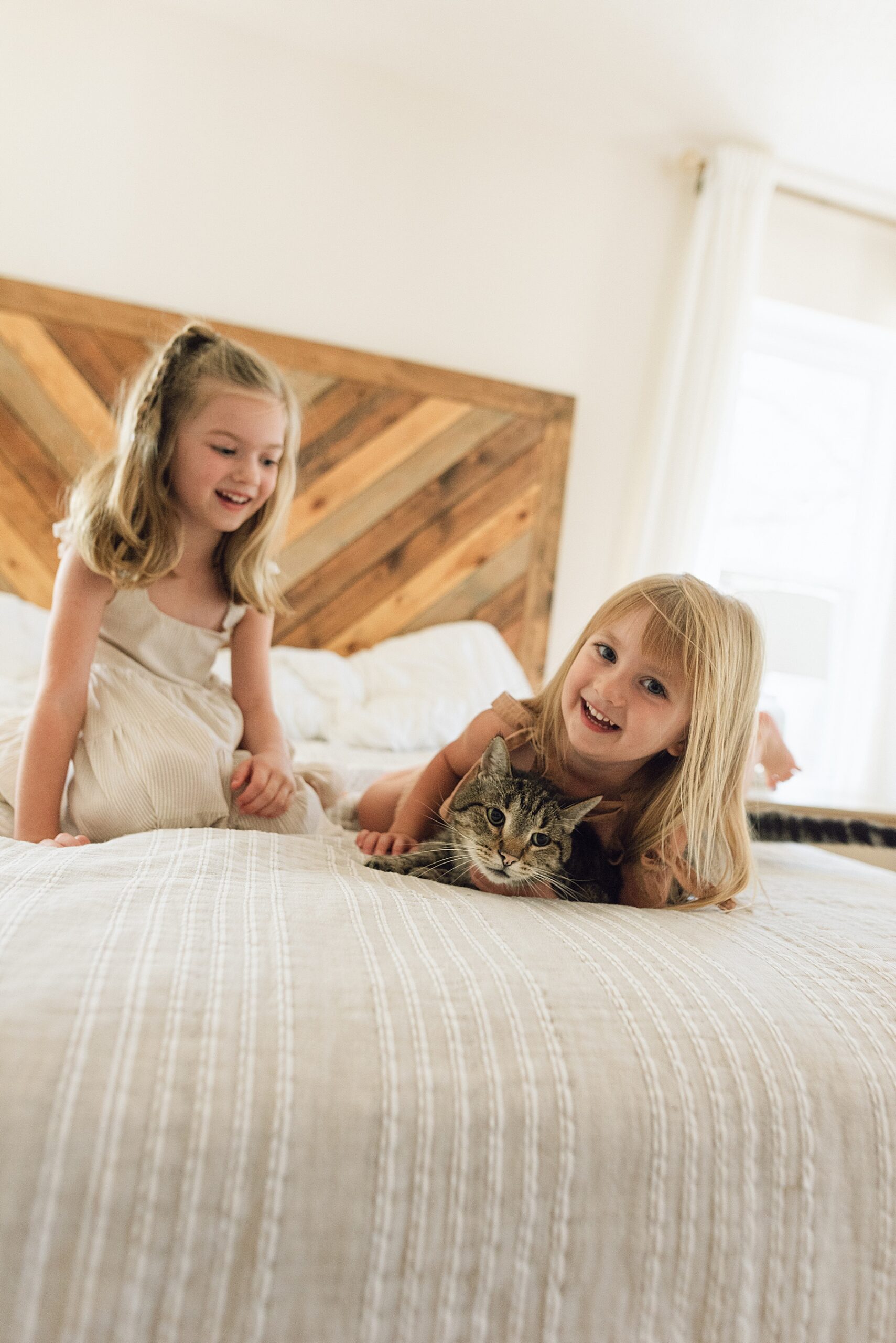 little girls play on bed during Bulverde, TX in-home session