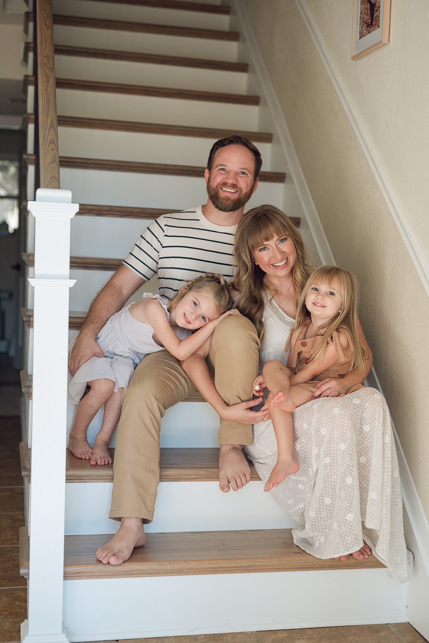family of four sits on stairs 