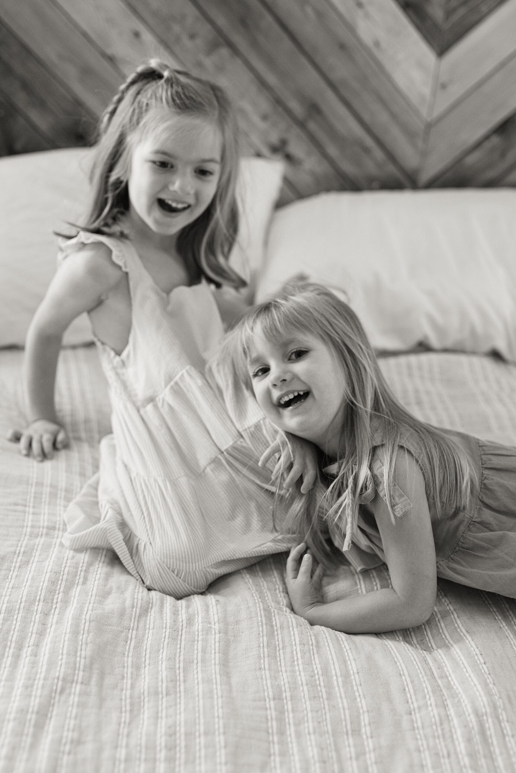little girls play on bed during Bulverde, TX in-home session
