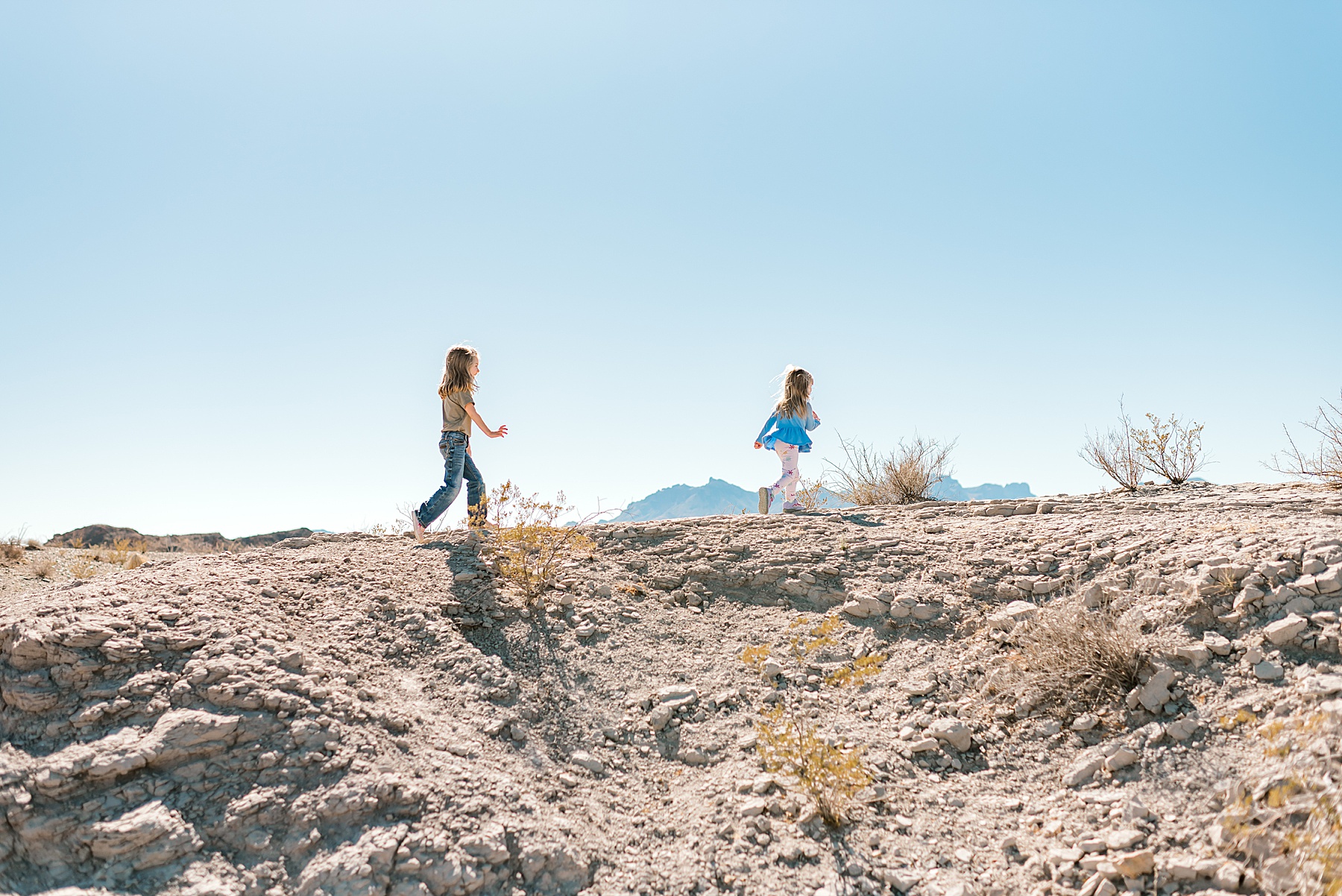 two girls running across the desert