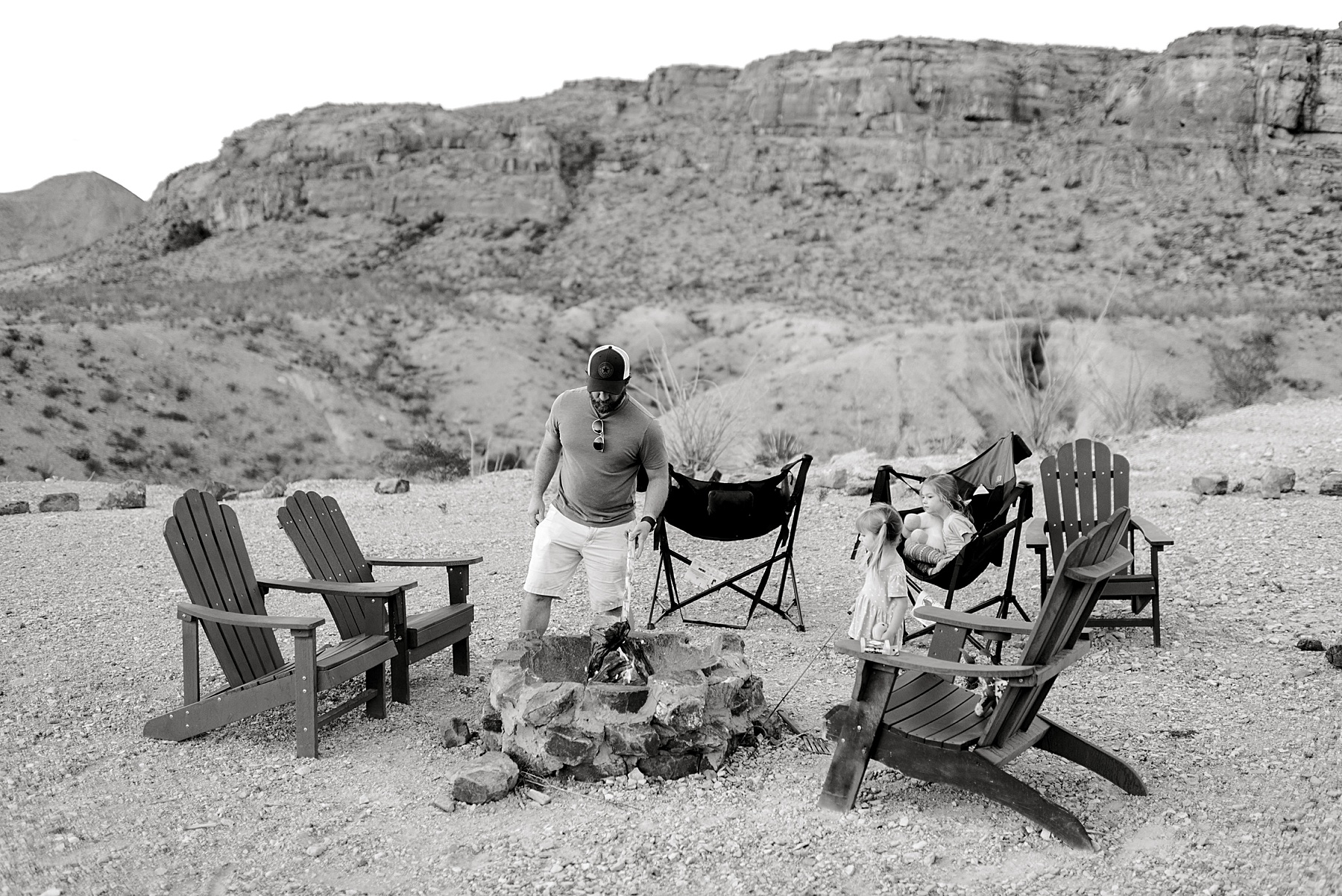 family sits around fire