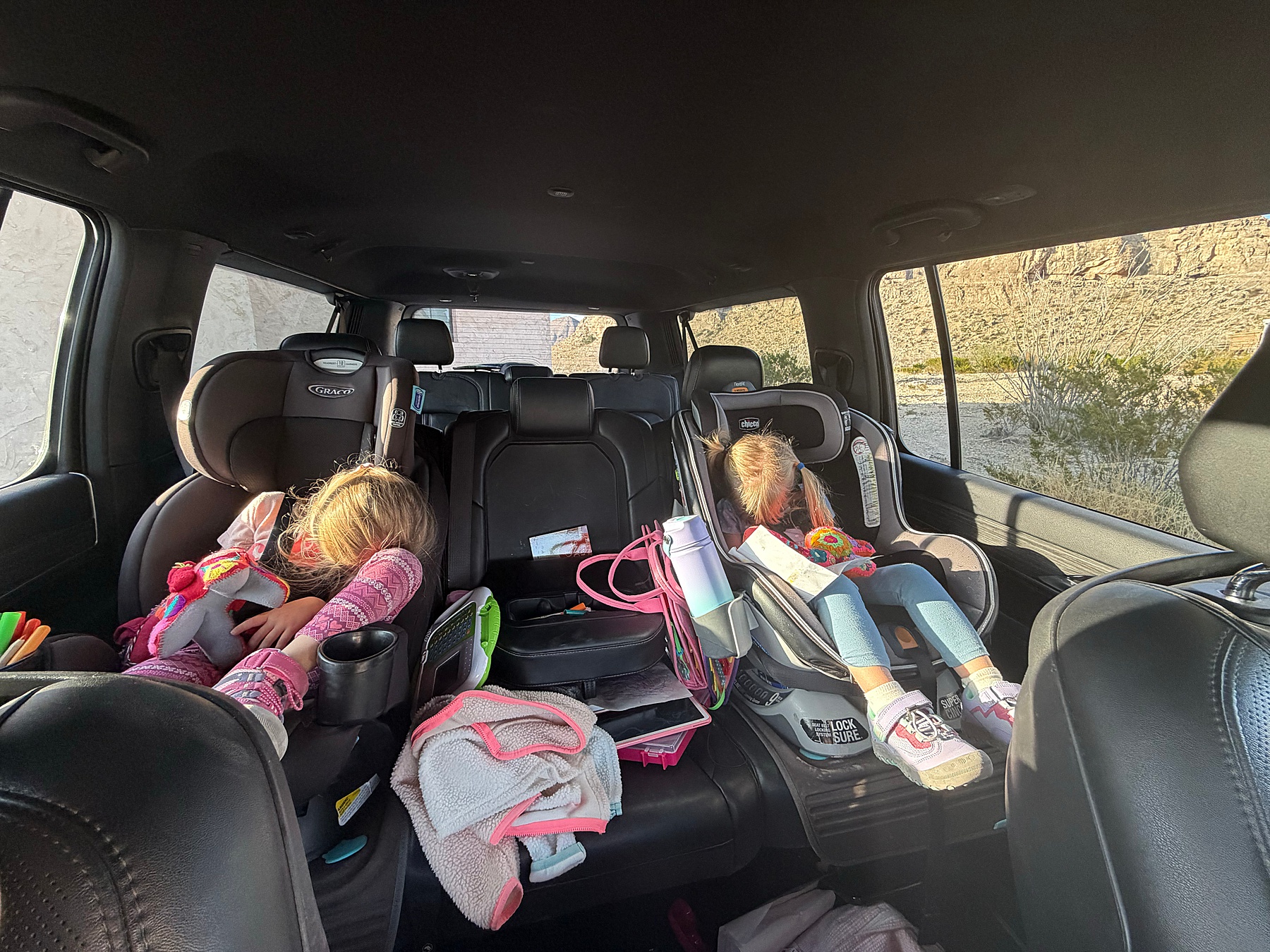 two girls asleep in car