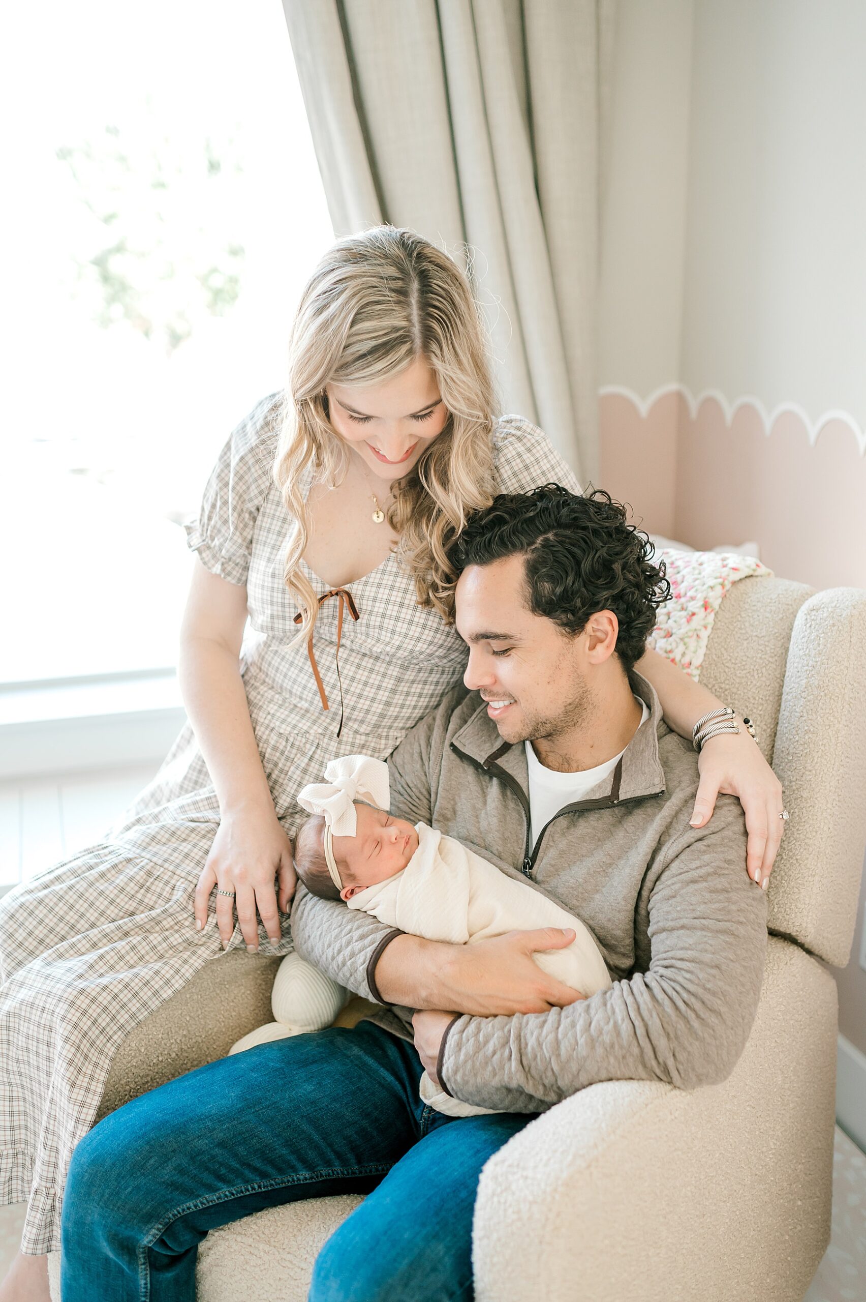 parents look down at newborn