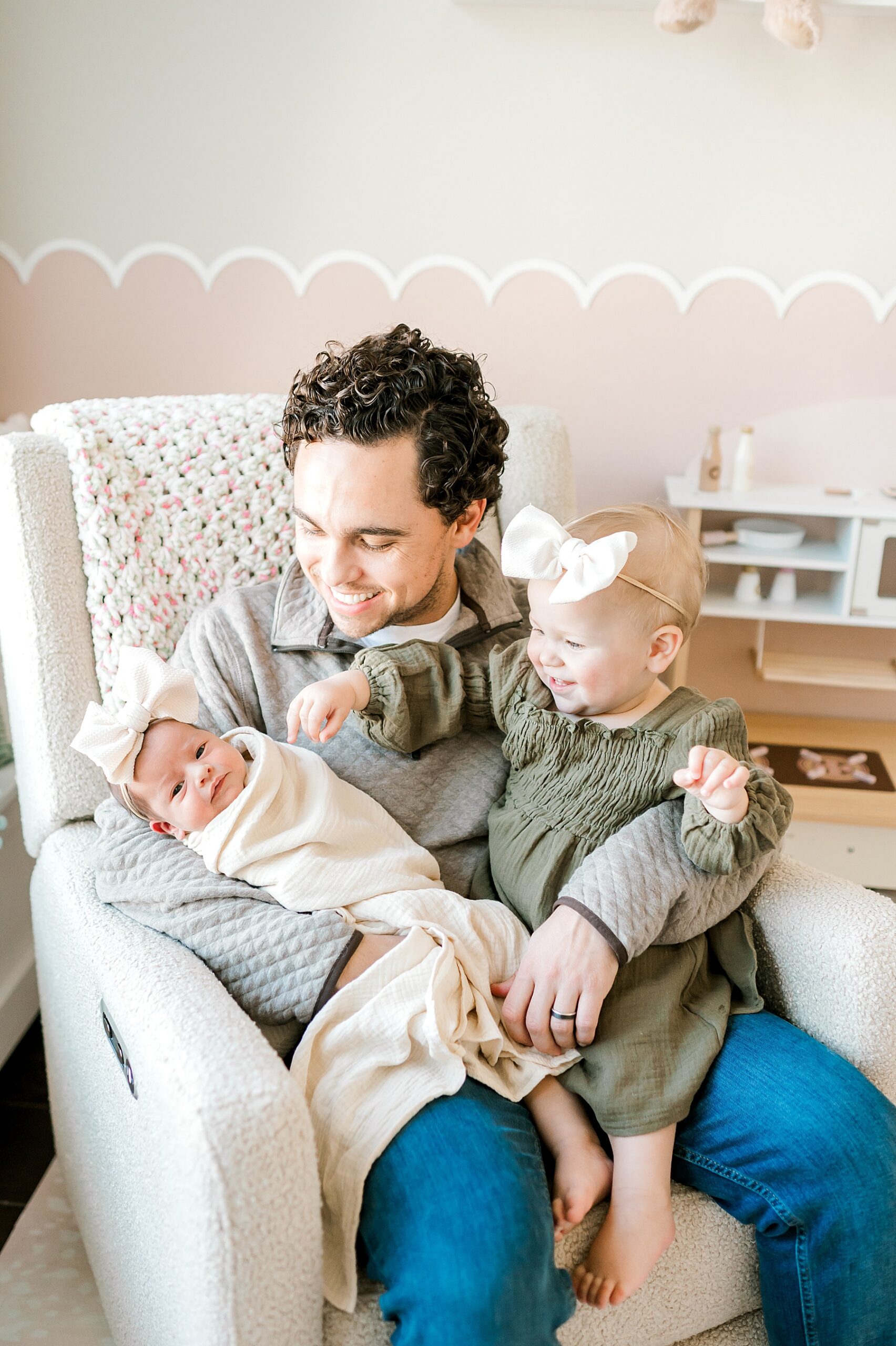 dad holding both of his daughters