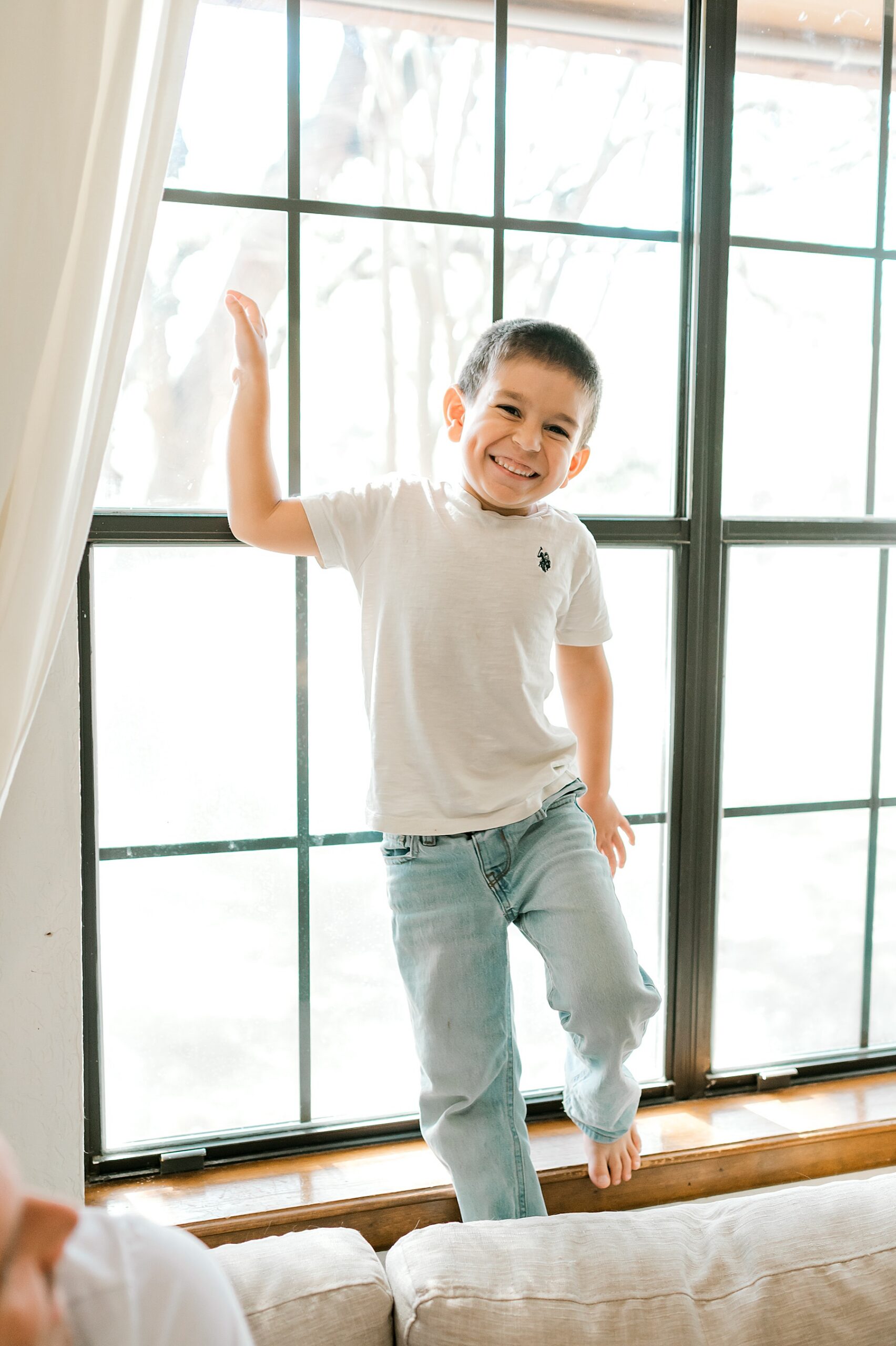 little boy on couch during in-home maternity session 