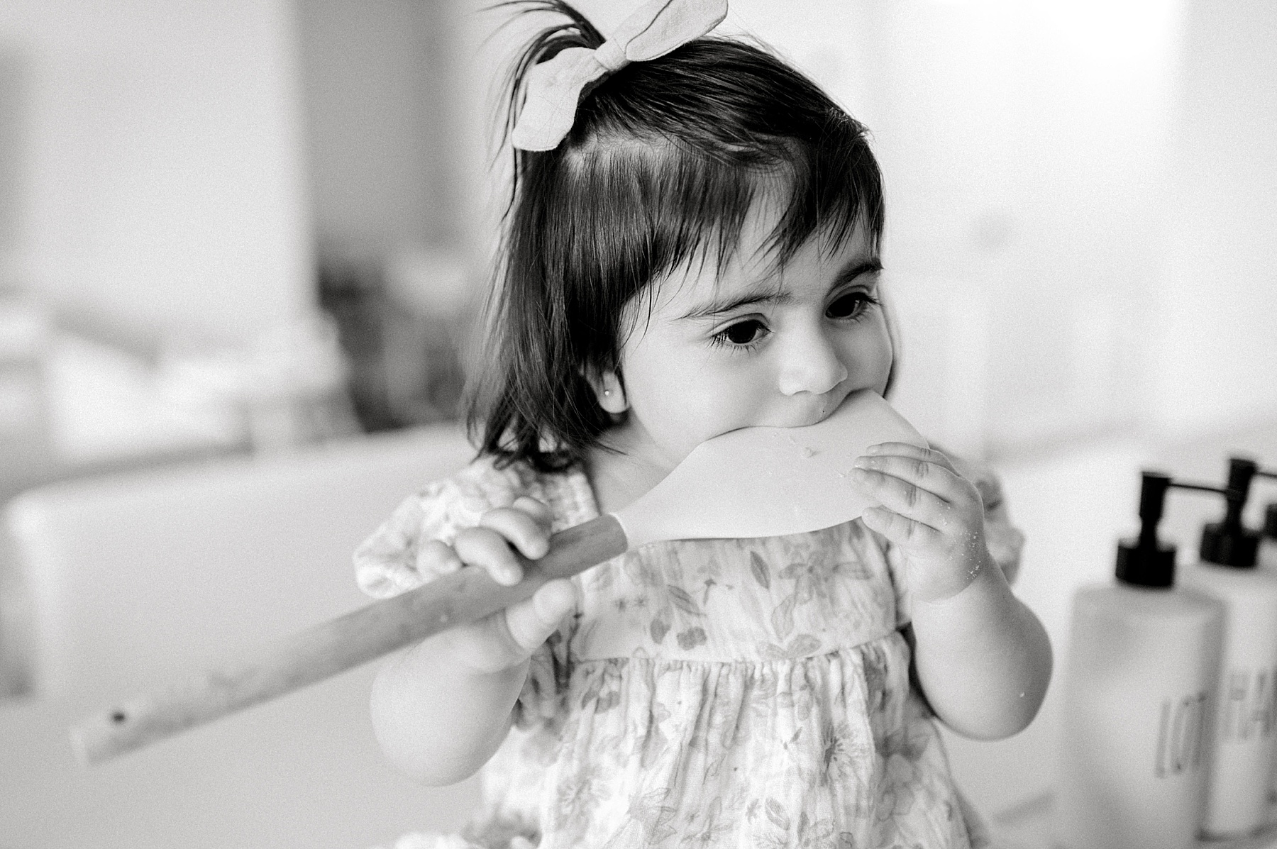 little girl licks spatula