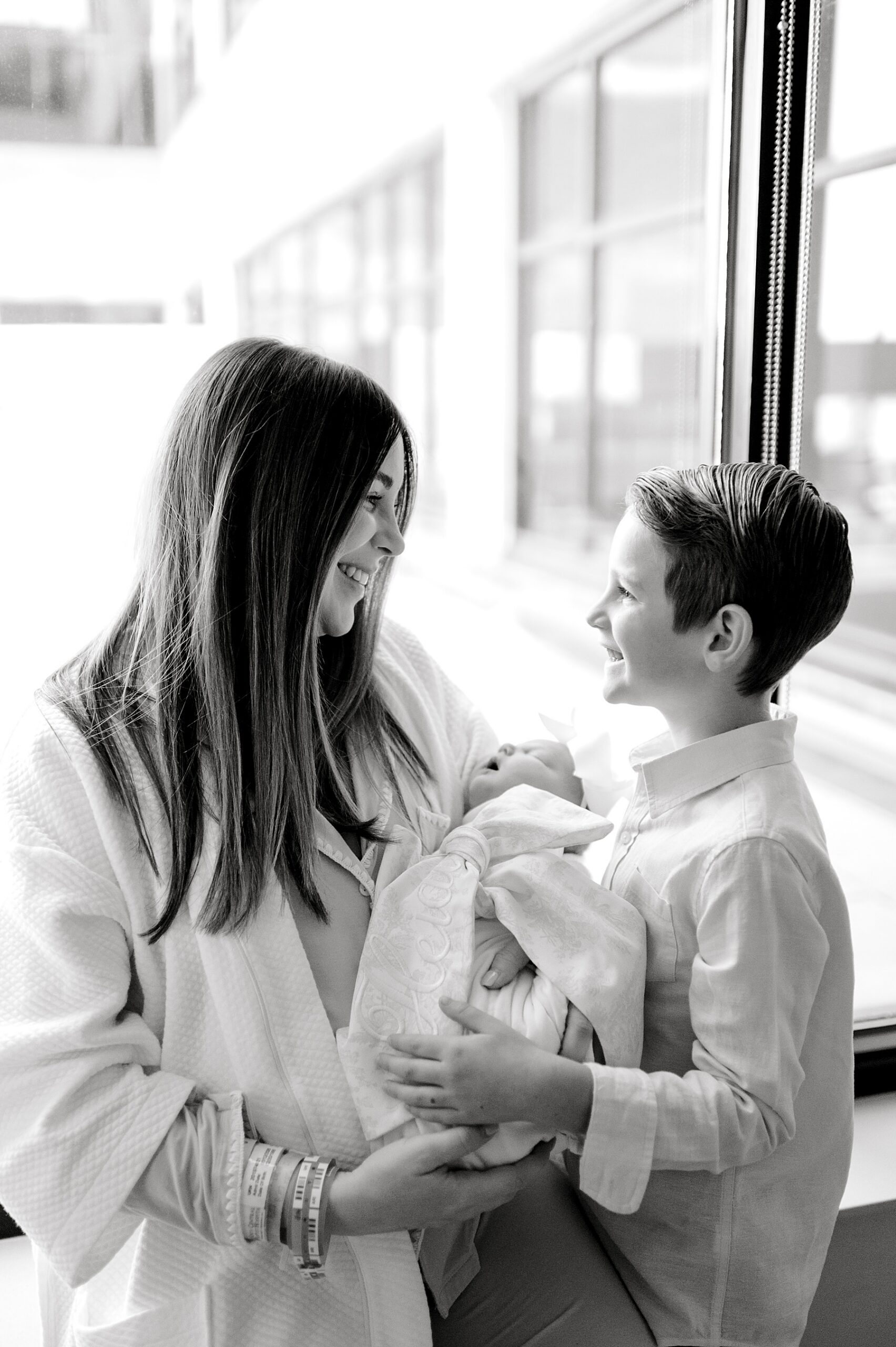 big brother and mom with newborn girl