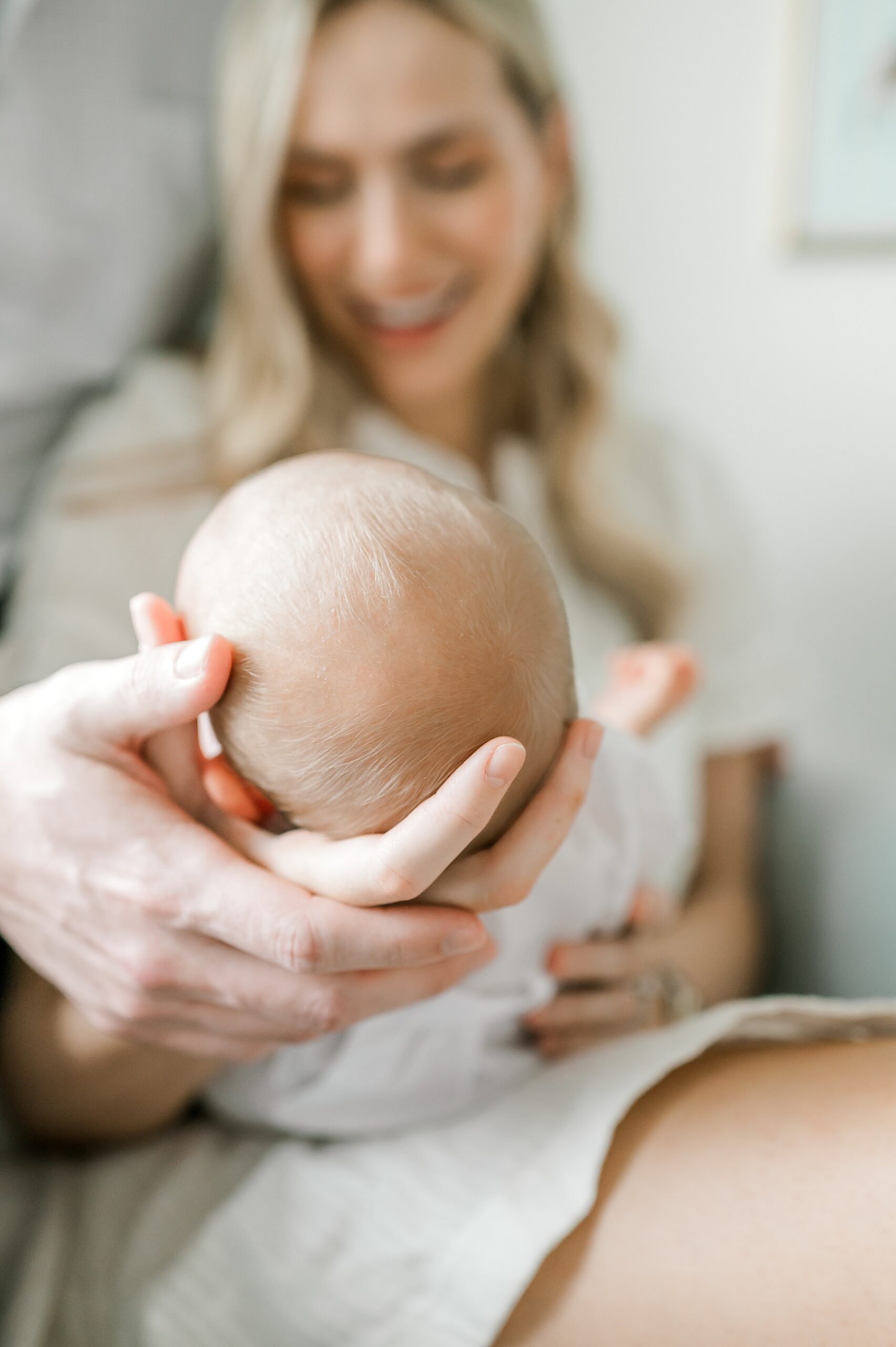 parents cradle newborn in nursery during in-home session