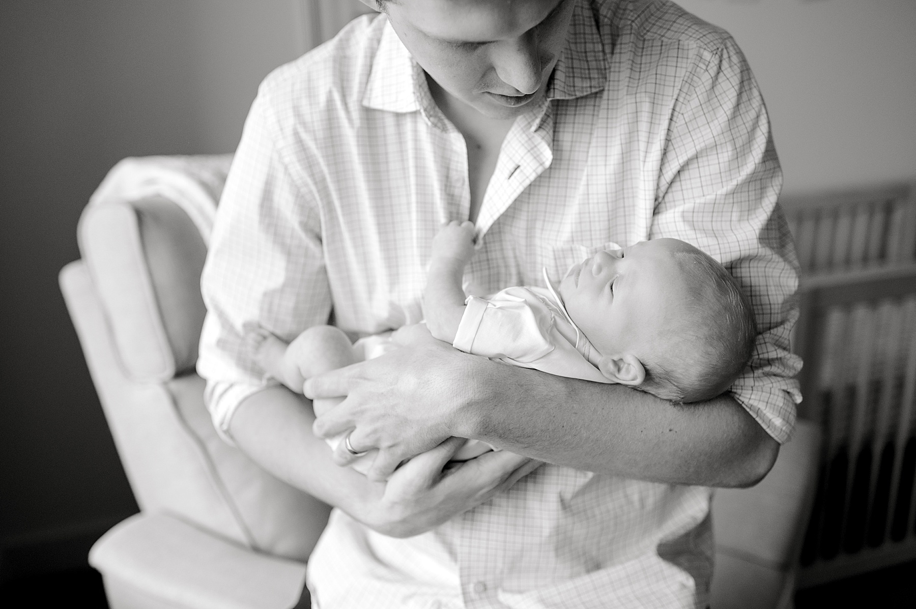 Timeless portraits of dad holding newborn | Why In-Home Newborn Photography is the Most Stress Free Option For New Moms