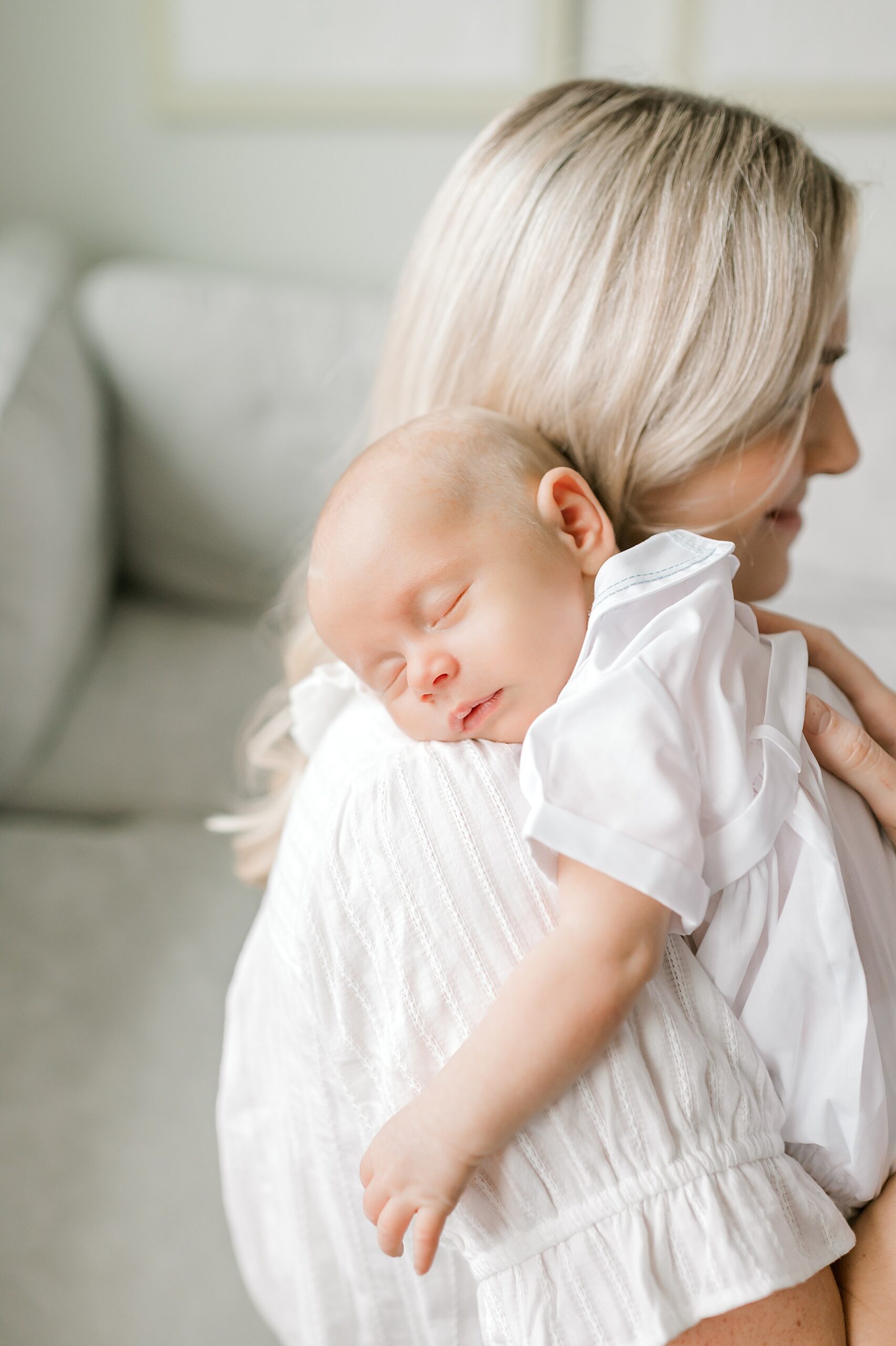 sleeping newborn on mom's shoulder 