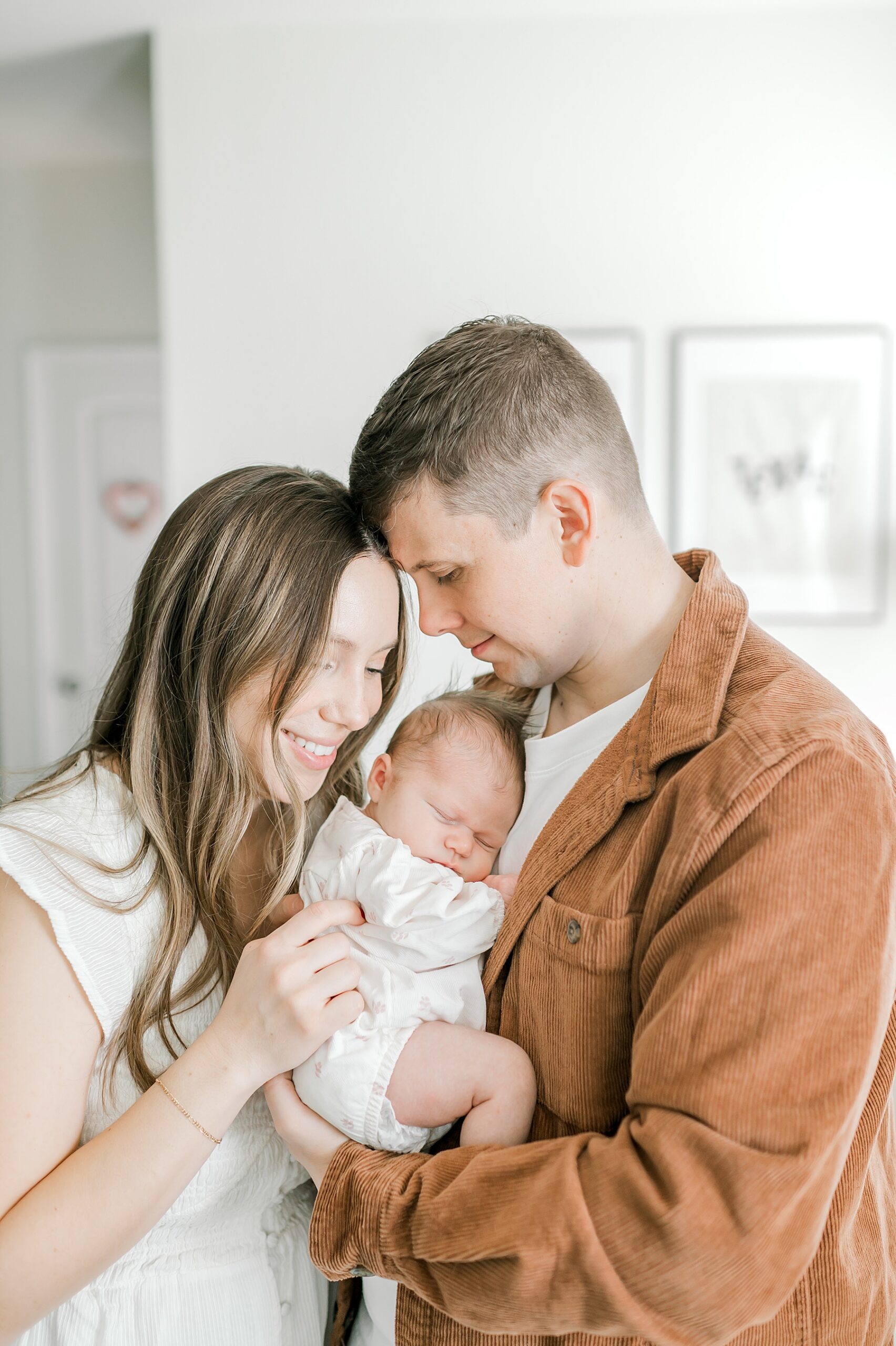 parents snuggle their newborn | in-home sessions focus on connection