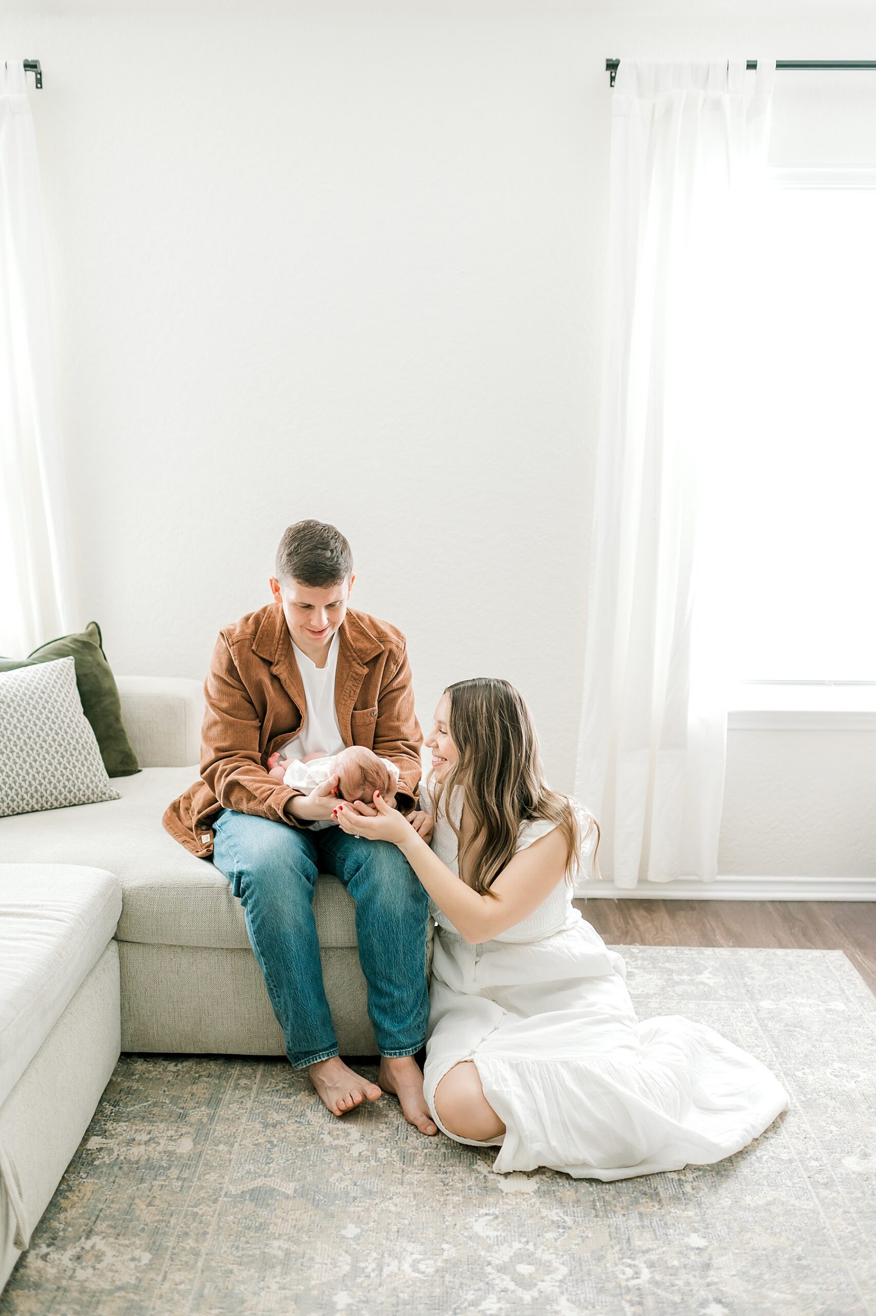 Tips to Prepare For An In-Home Newborn Session | Family sits together in living room during in-home newborn session 
