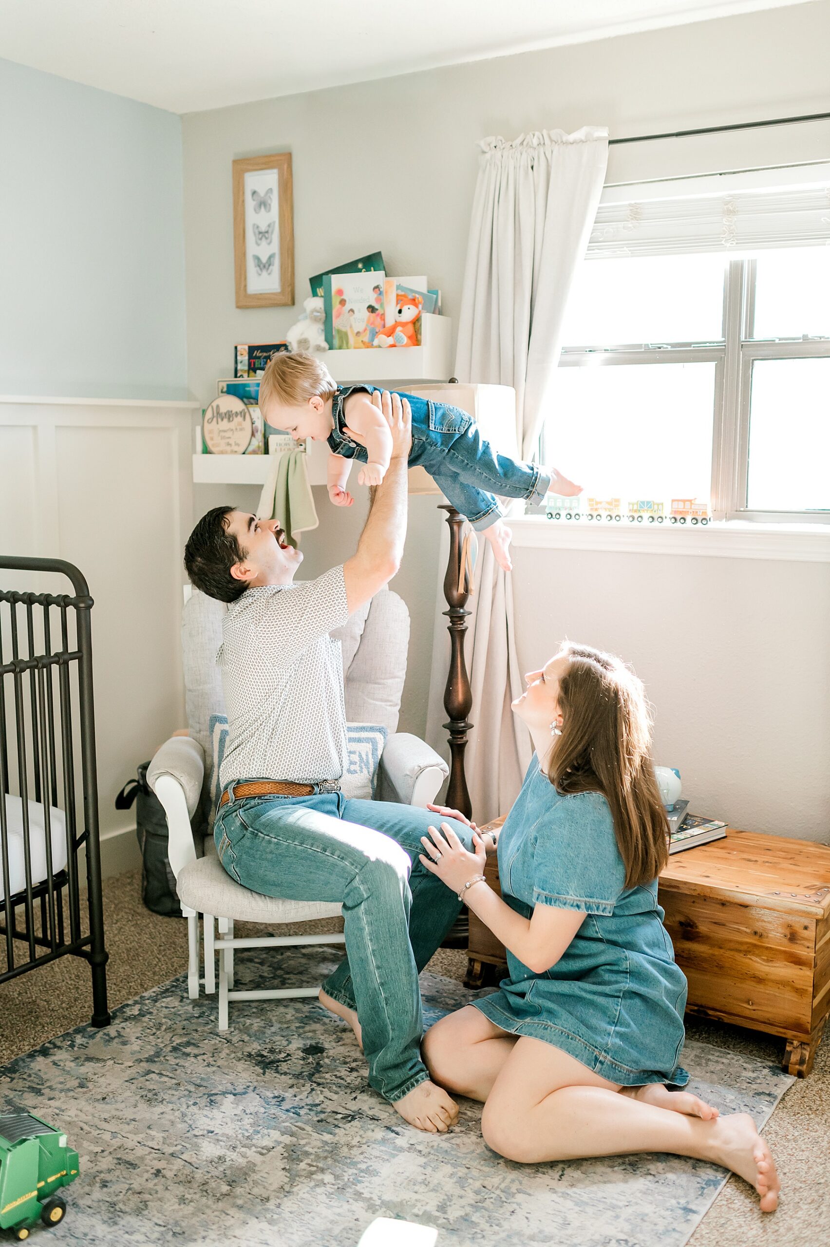 parents with their one year old in nursery for one year portraits 
